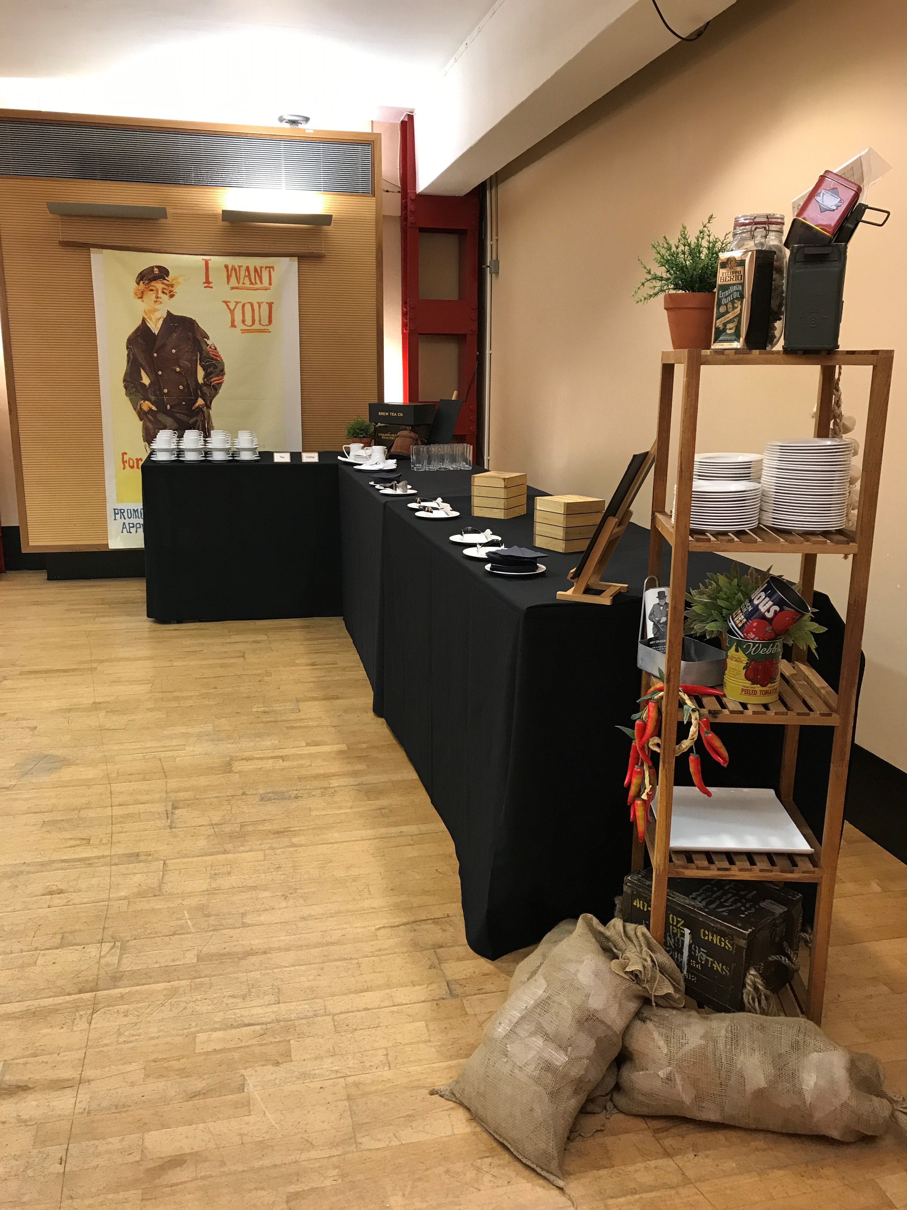HCA Auditorium refreshment station for meetings with vintage decor and greenery.