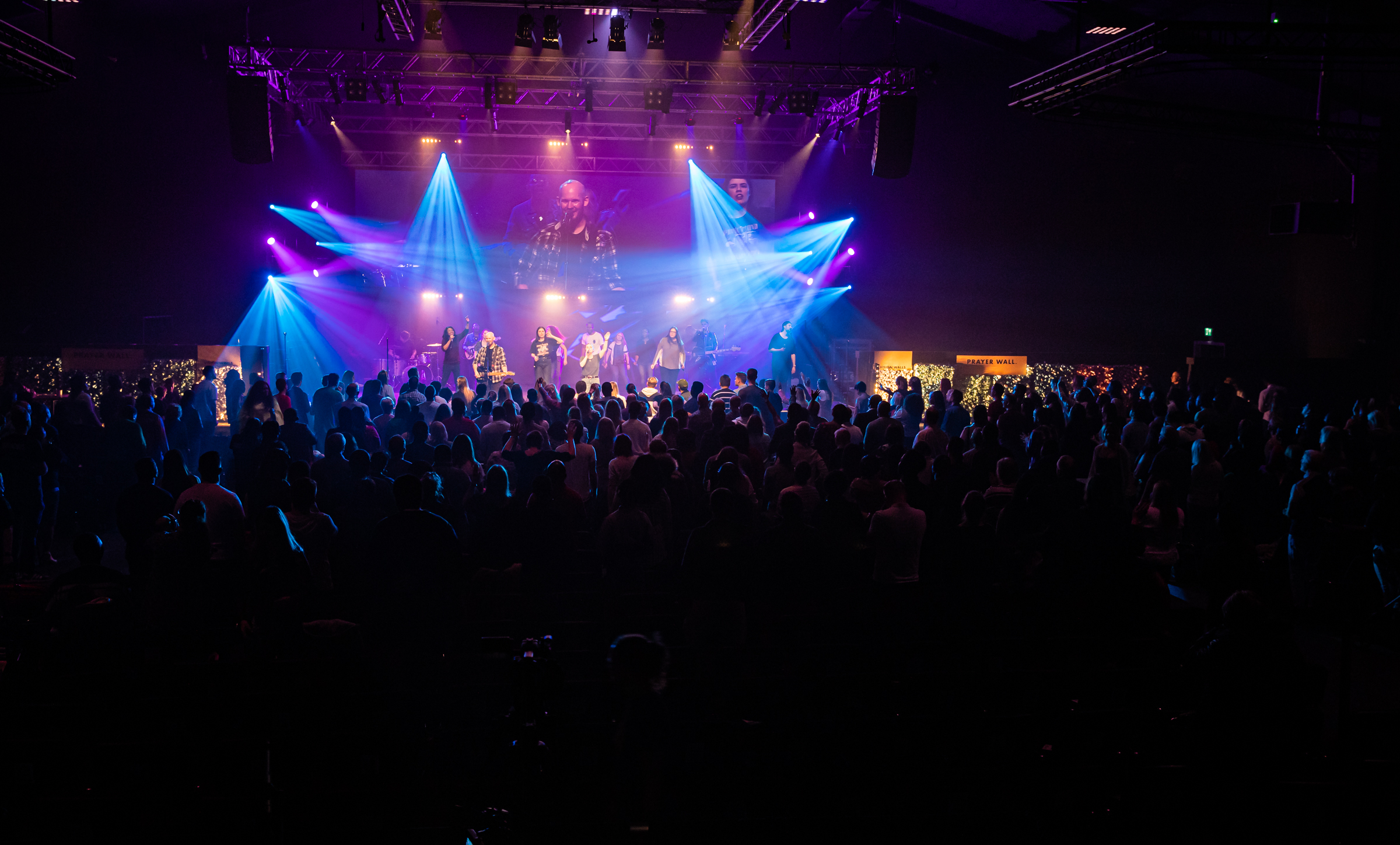 Vibrant auditorium with dynamic lighting at a live concert event.