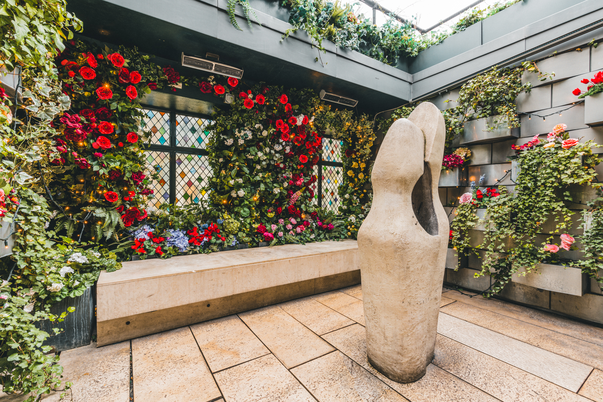 The Loft at The Ivy Club: vibrant floral walls, ideal for events and gatherings.