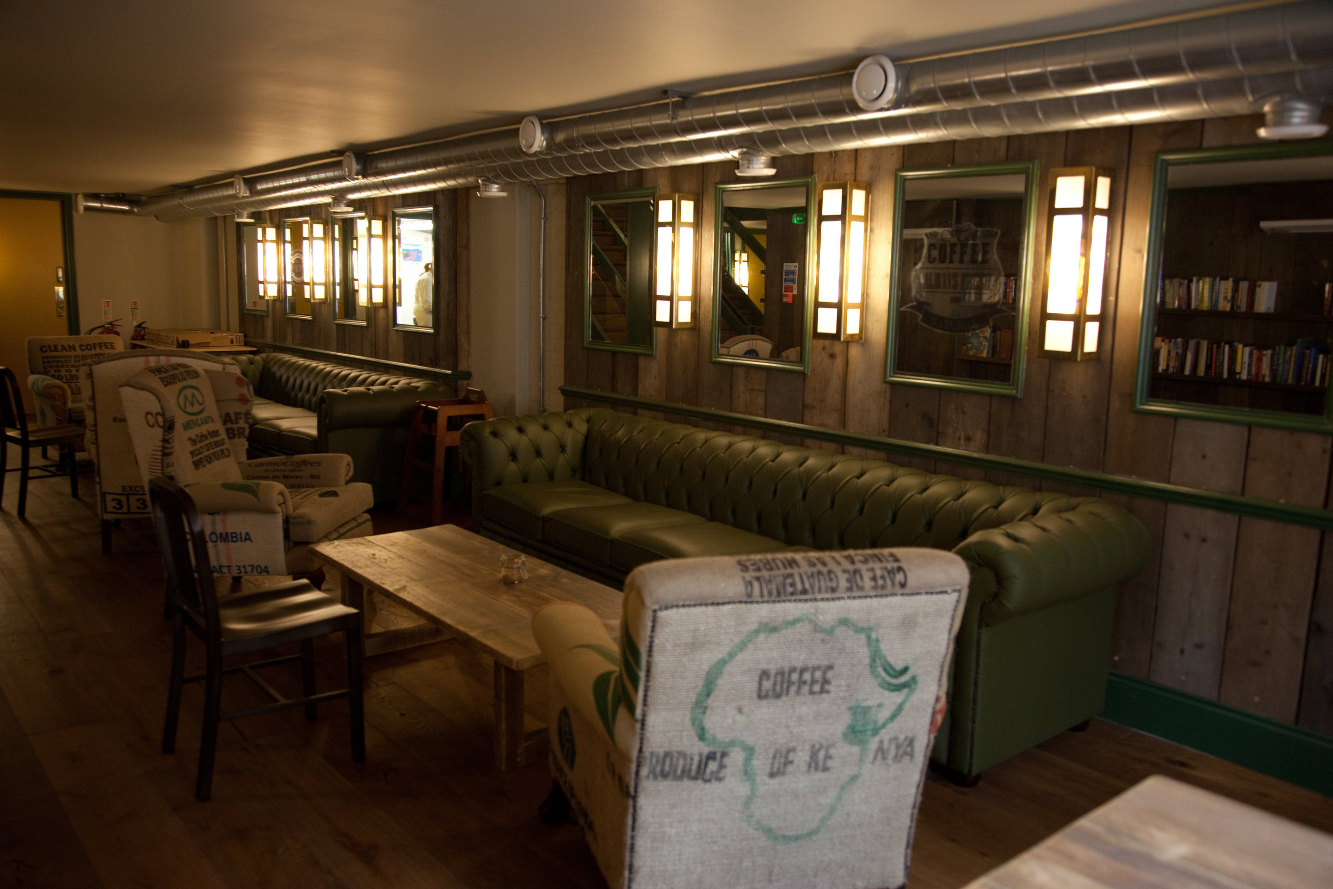 Cozy meeting space in Cafe Zee with warm lighting, ideal for team-building events.