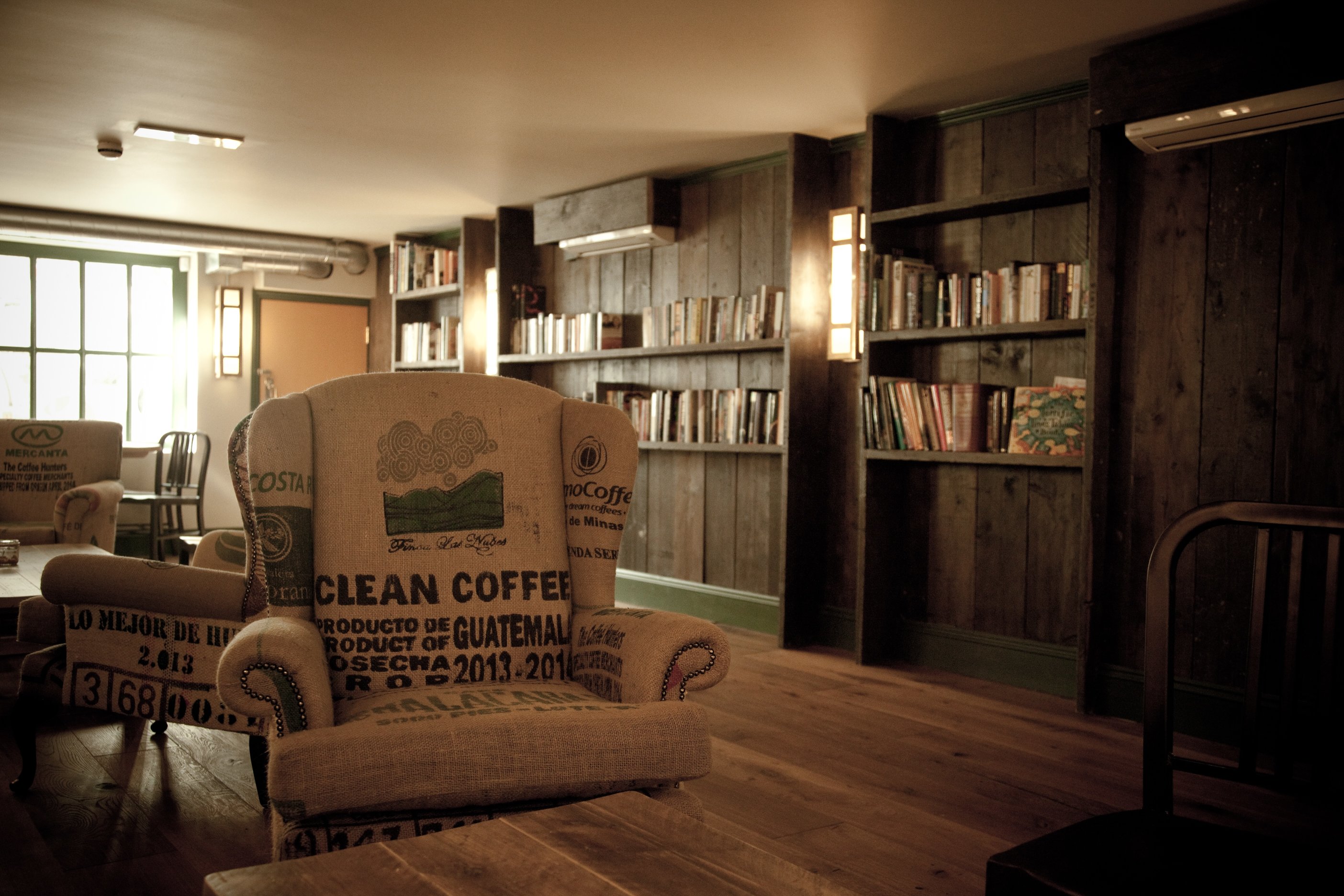 Cozy meeting space in Cafe Zee with bookshelves for casual gatherings and brainstorming.