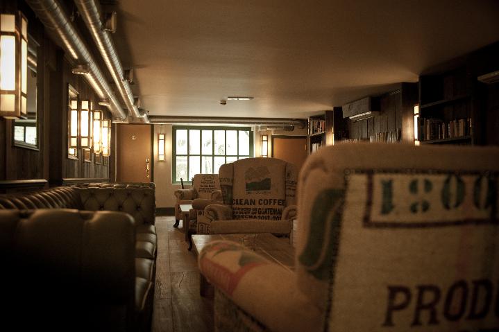 Cozy basement meeting space at Cafe Zee with warm lighting for gatherings and brainstorming.