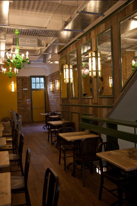 Cozy venue at Cafe Zee, featuring warm lighting for intimate meetings and events.