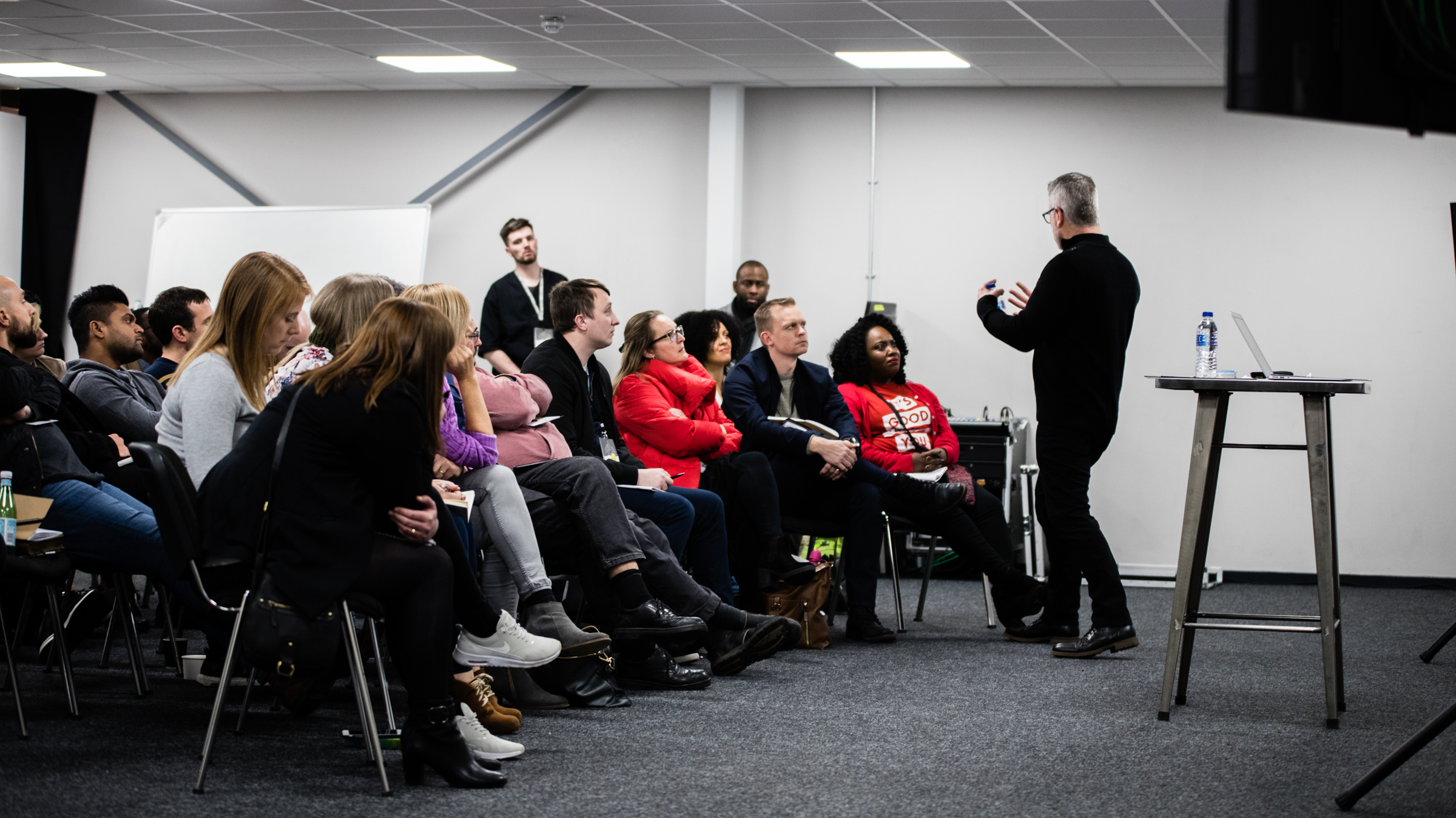 Dynamic audience engaged in a presentation at !Audacious Conferencing event.