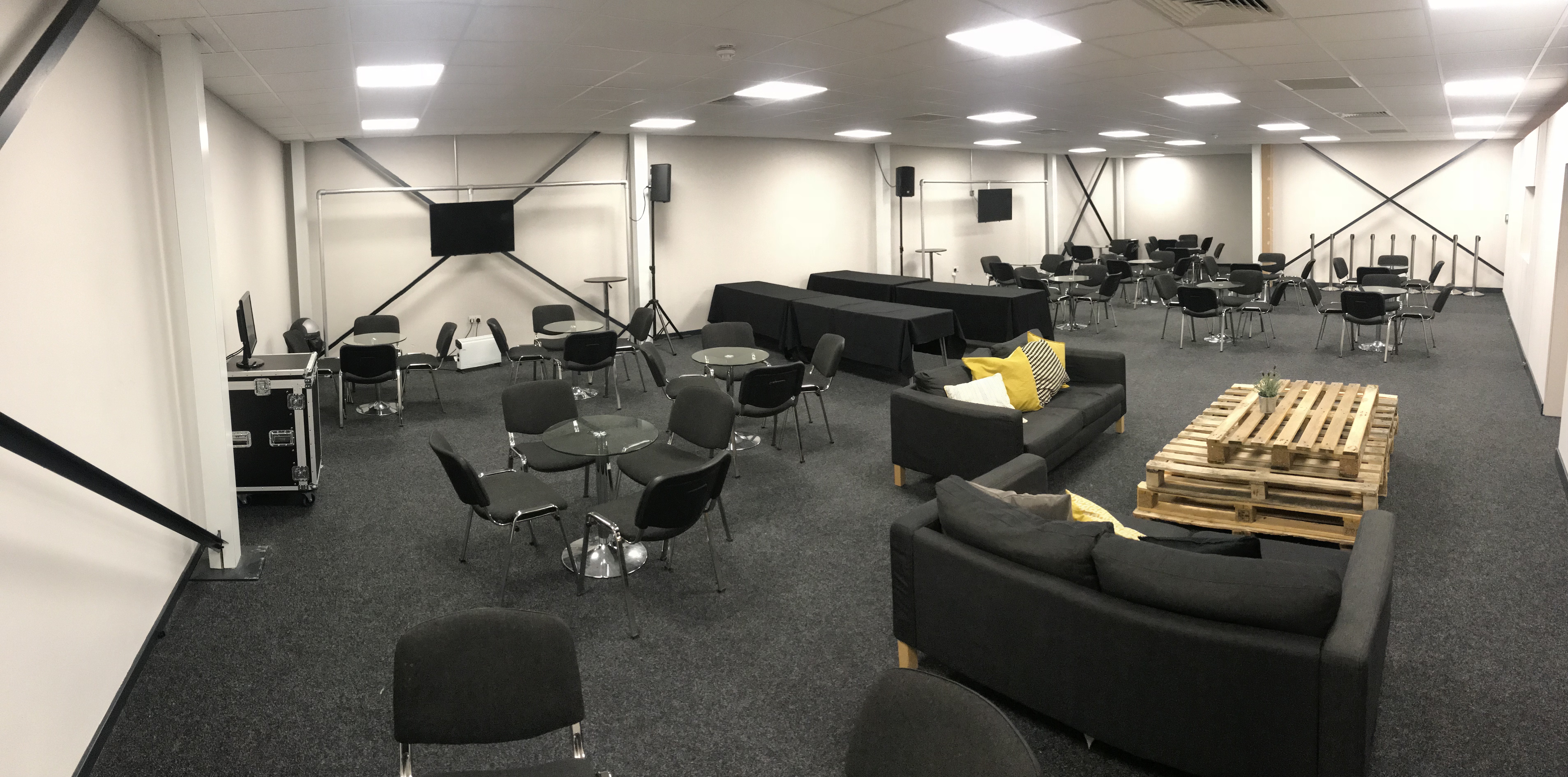 Versatile event space with comfortable seating for networking and presentations.