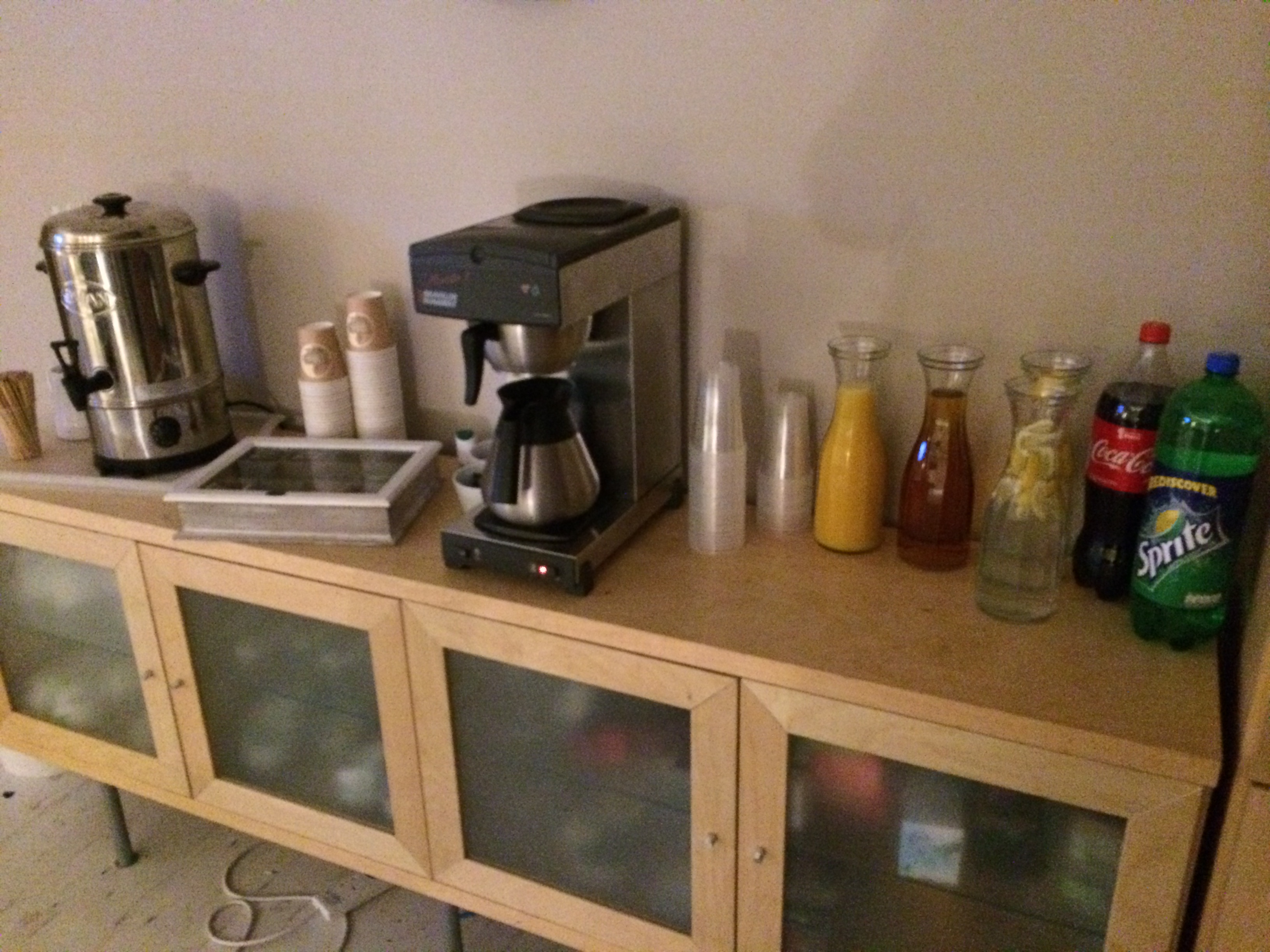 Refreshment station with coffee maker and drinks for event attendees at !Audacious Conferencing.