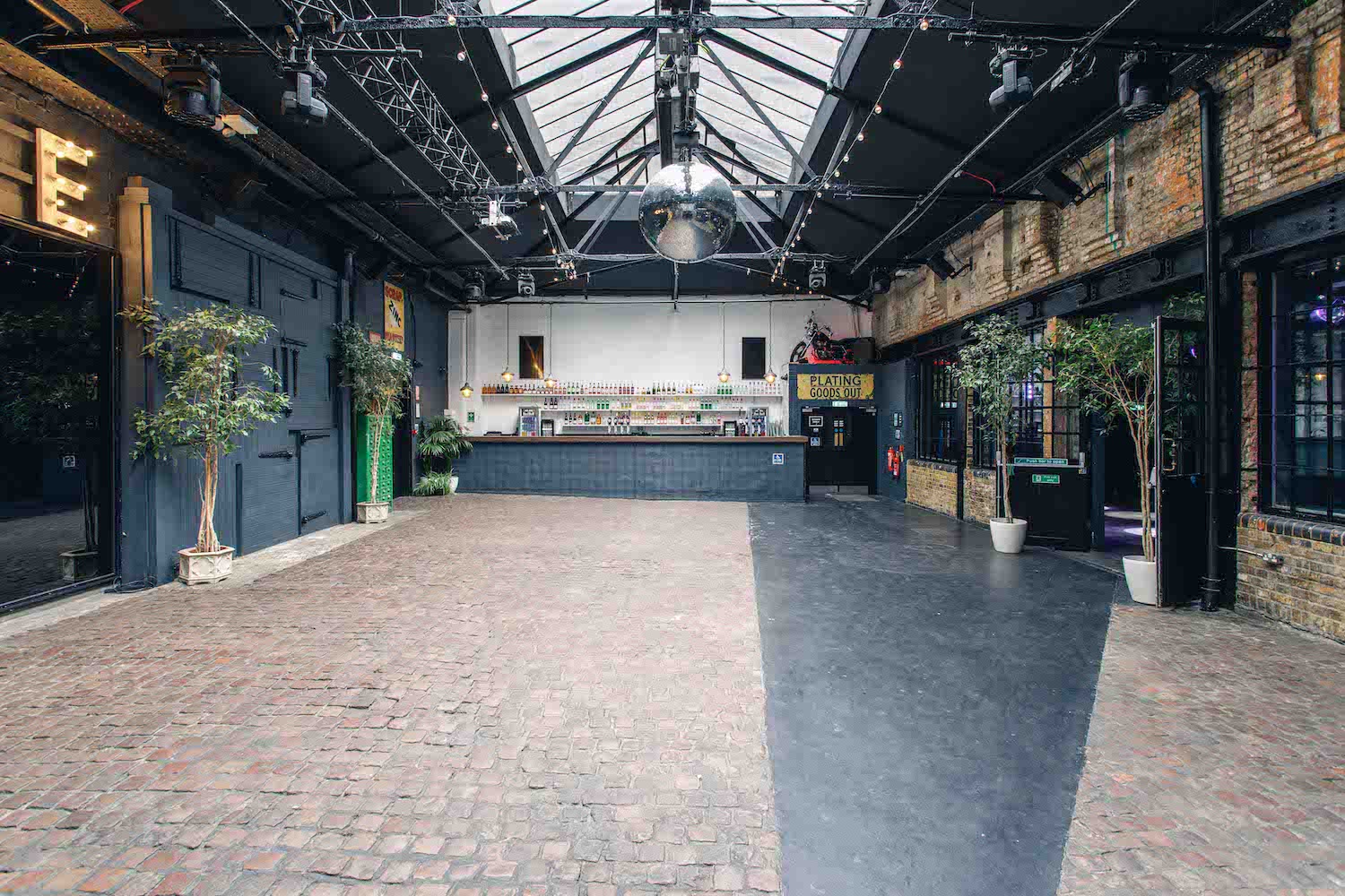 Industrial venue: exposed brick, metal beams, natural light, corporate launch, brand experience.