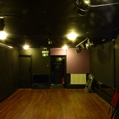 Fringe Theatre event space with dark walls, ideal for workshops and performances.