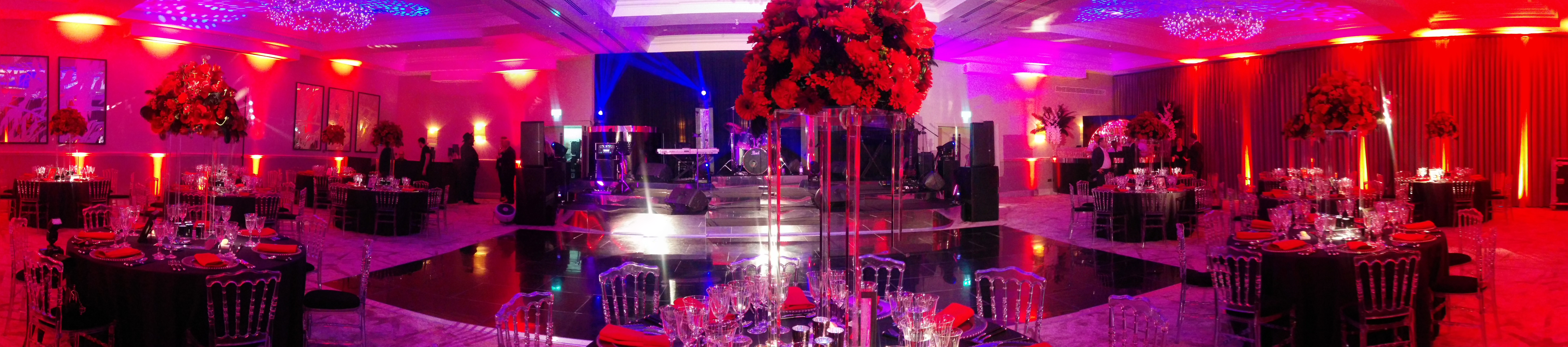 Elegant event space at Primrose Hill, London Marriott, with red floral centerpieces.