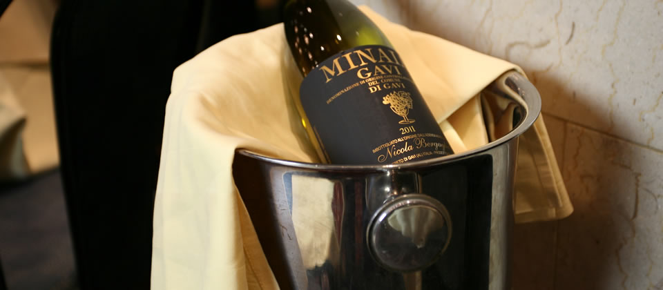 Elegant wine bottle in silver ice bucket at Bolton's Main Restaurant for upscale events.