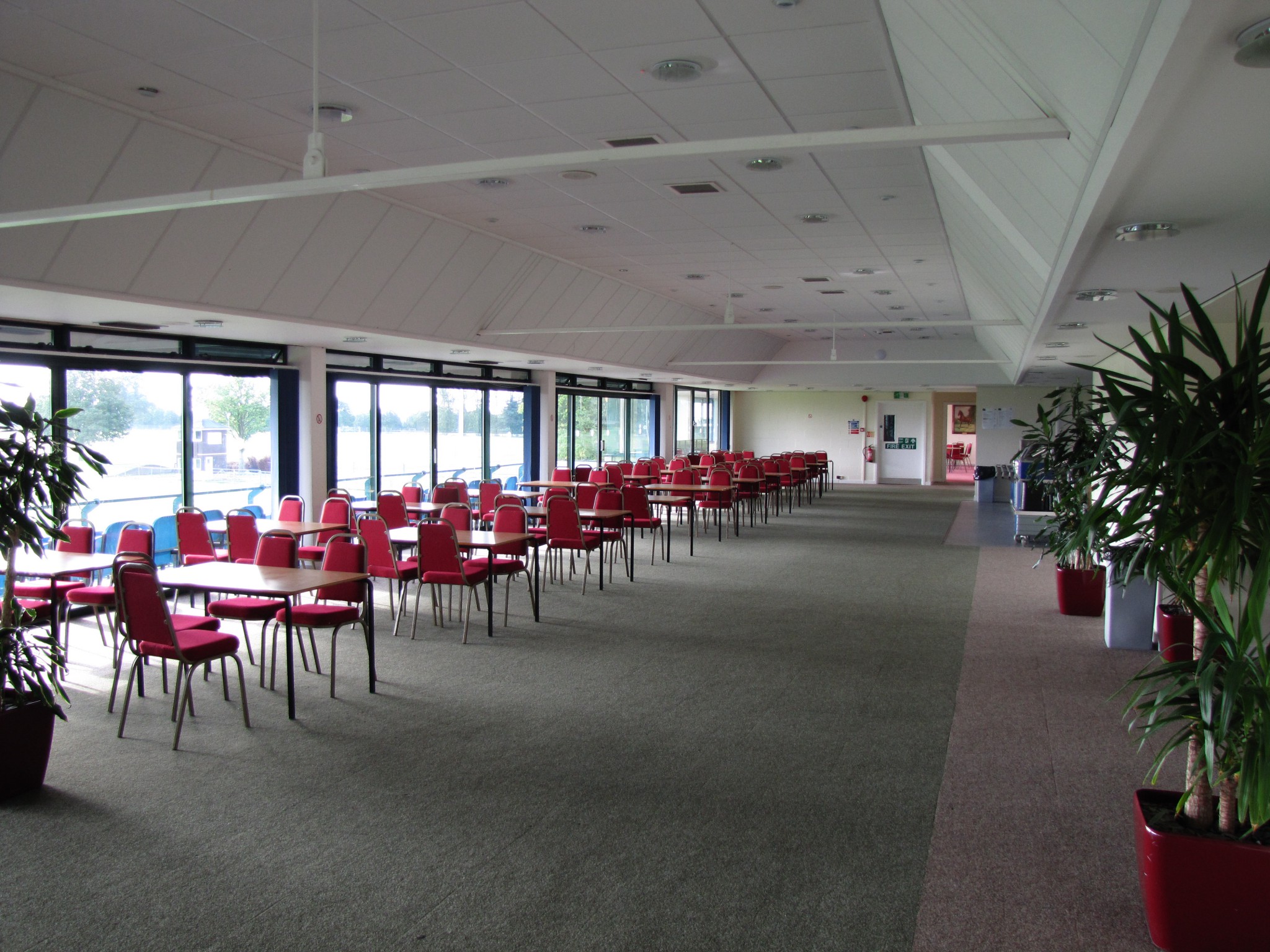 Balcombe Room: spacious event venue with red chairs for meetings and conferences.