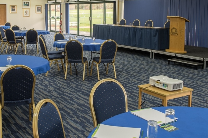Ardingly Room meeting space with blue tablecloths, ideal for conferences and events.