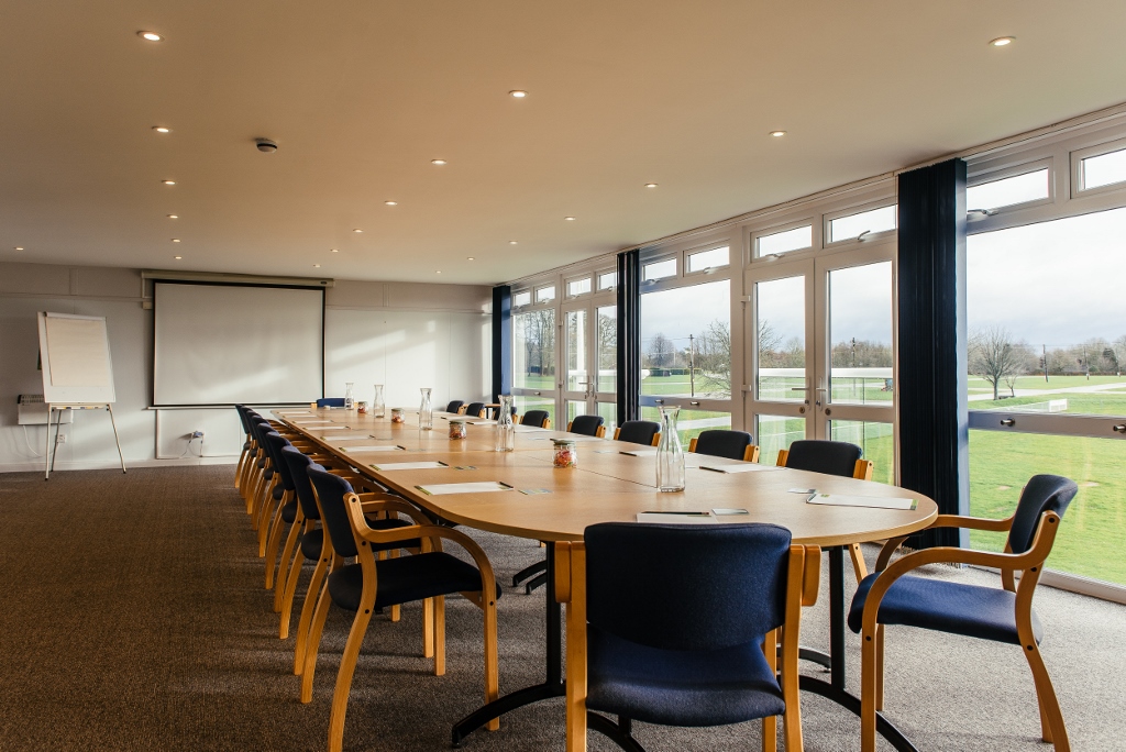 Lindfield Room conference space with oval table, ideal for meetings and events.
