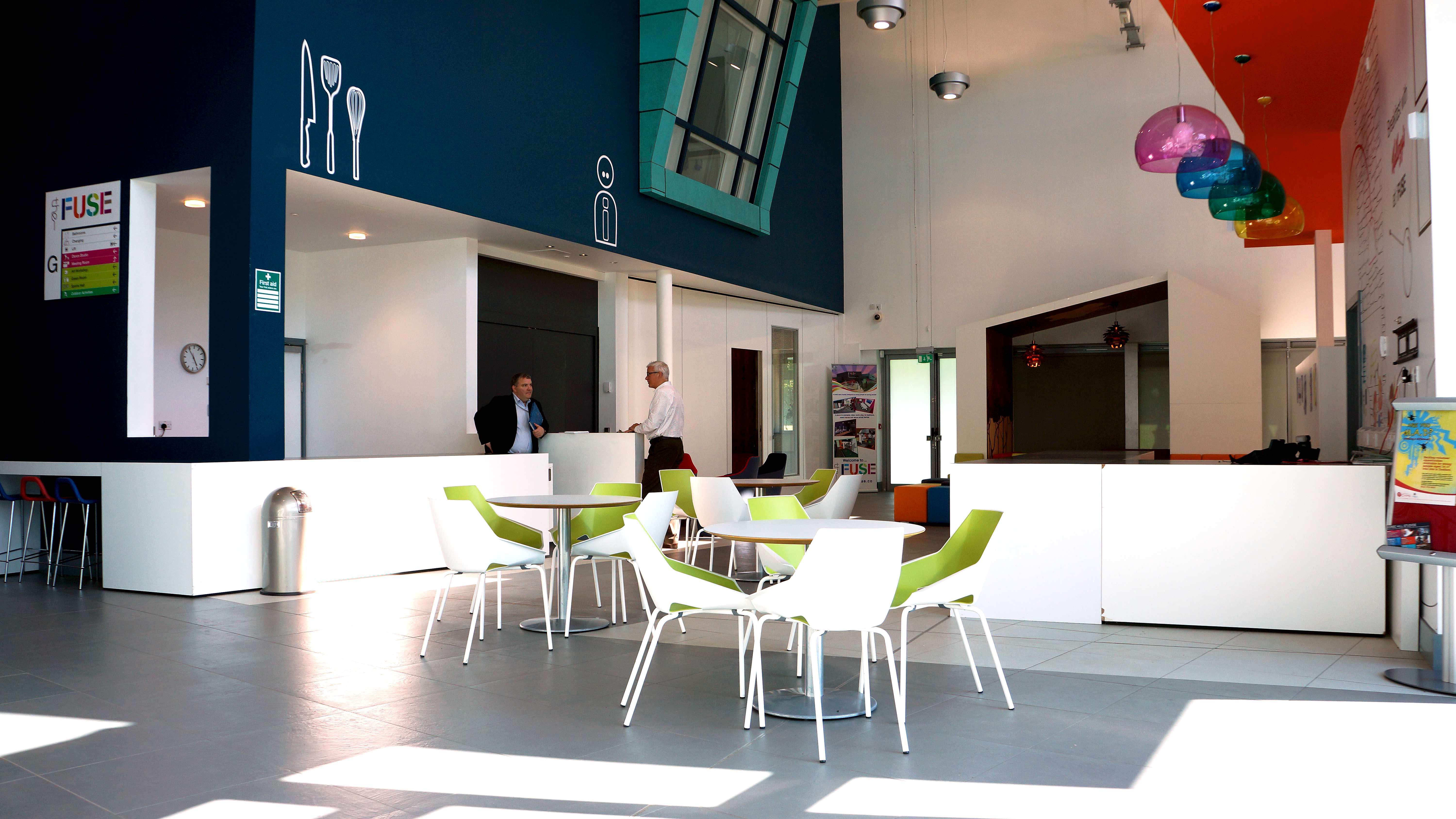 Modern auditorium with bright colors, ideal for networking events and casual meetings.