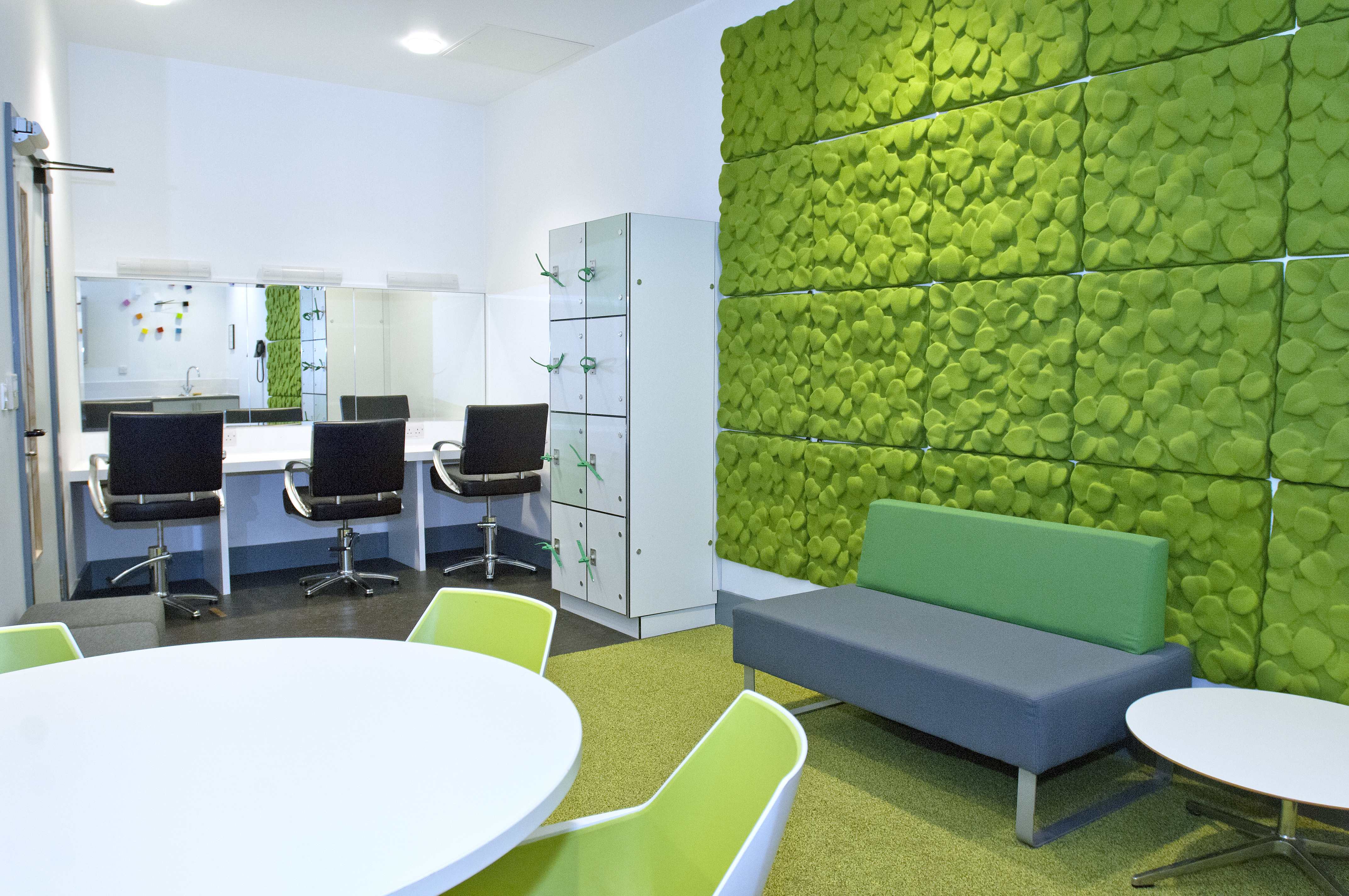 Modern auditorium with green wall, perfect for brainstorming sessions and team workshops.