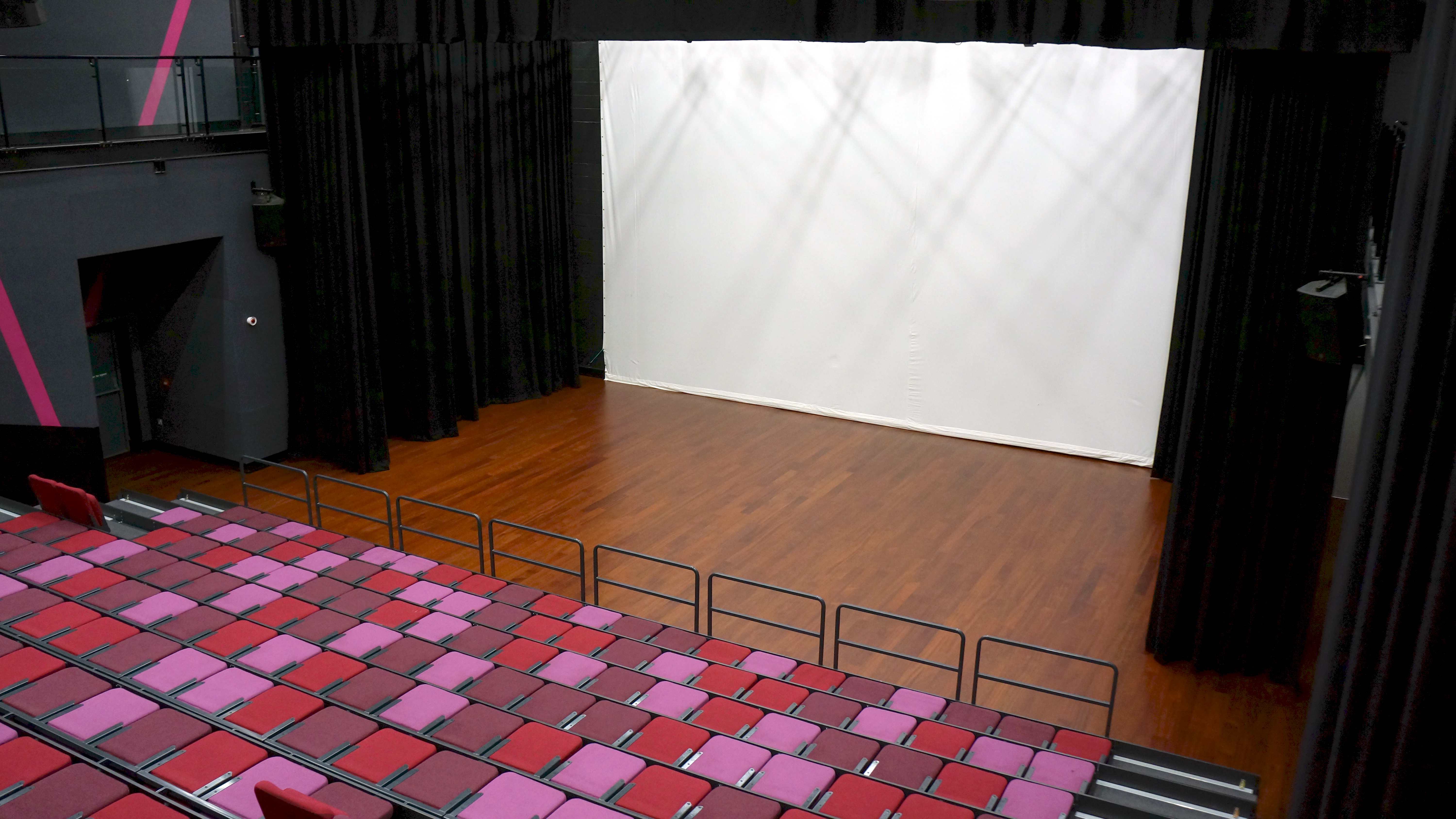 Versatile auditorium with spacious stage and tiered seating for events and performances.
