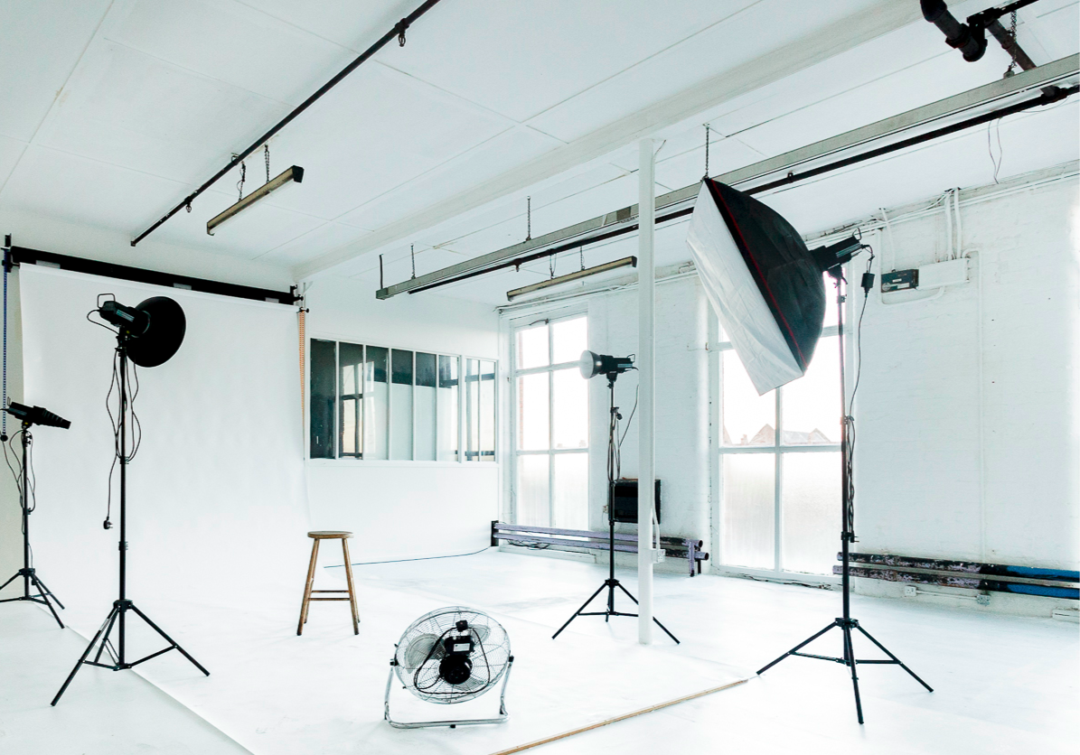 Versatile art studio space with natural light for creative events and photo shoots.