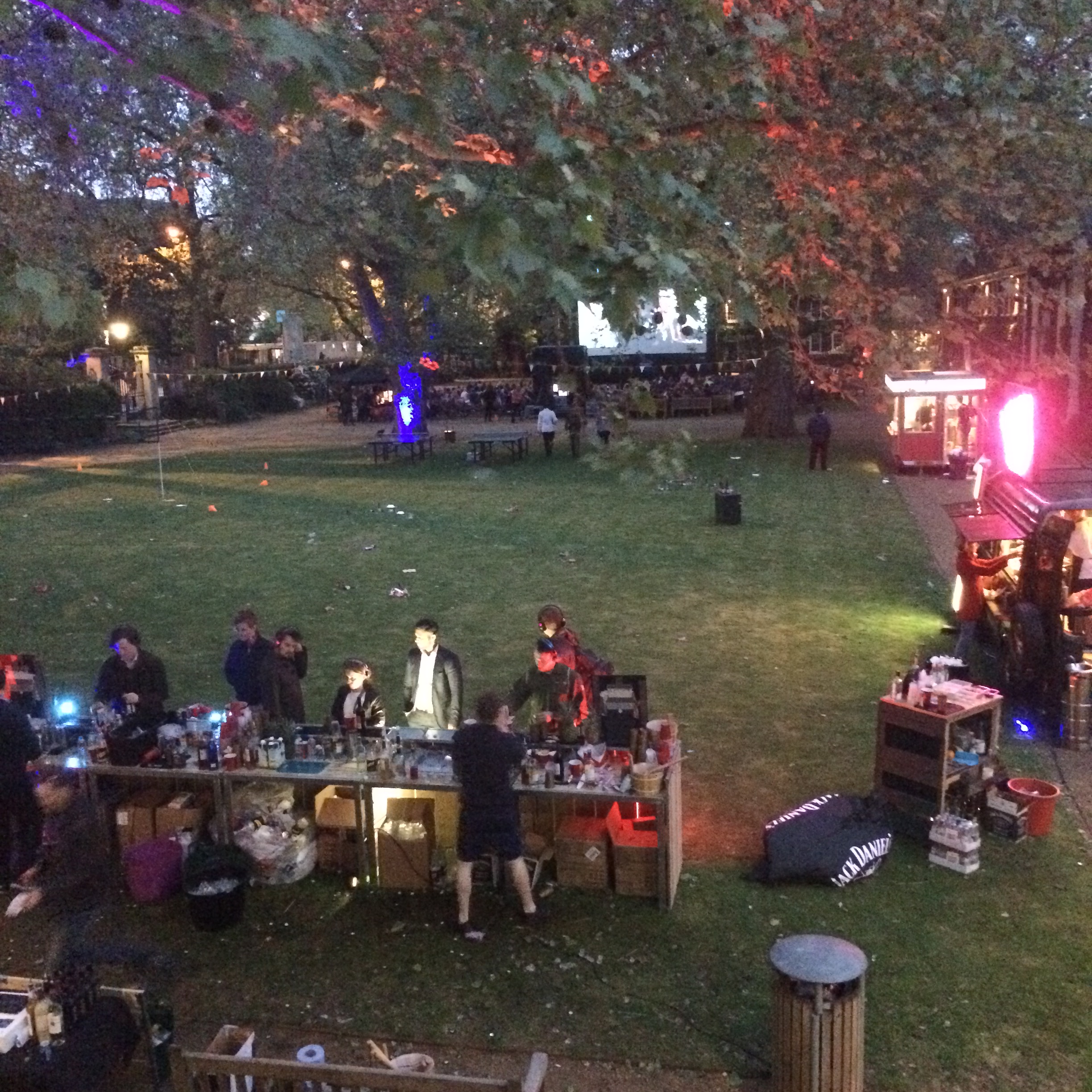 Vibrant outdoor event at The Museum of the Home with bar and lush greenery.