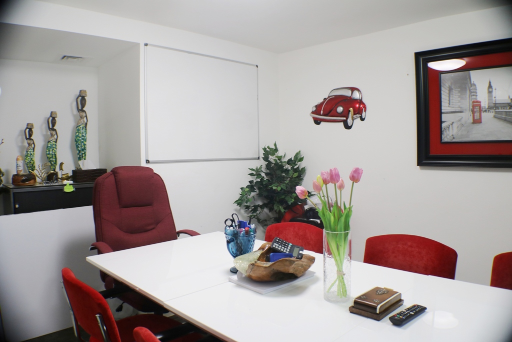Modern meeting room with red chairs, perfect for creative corporate events near Liverpool St.