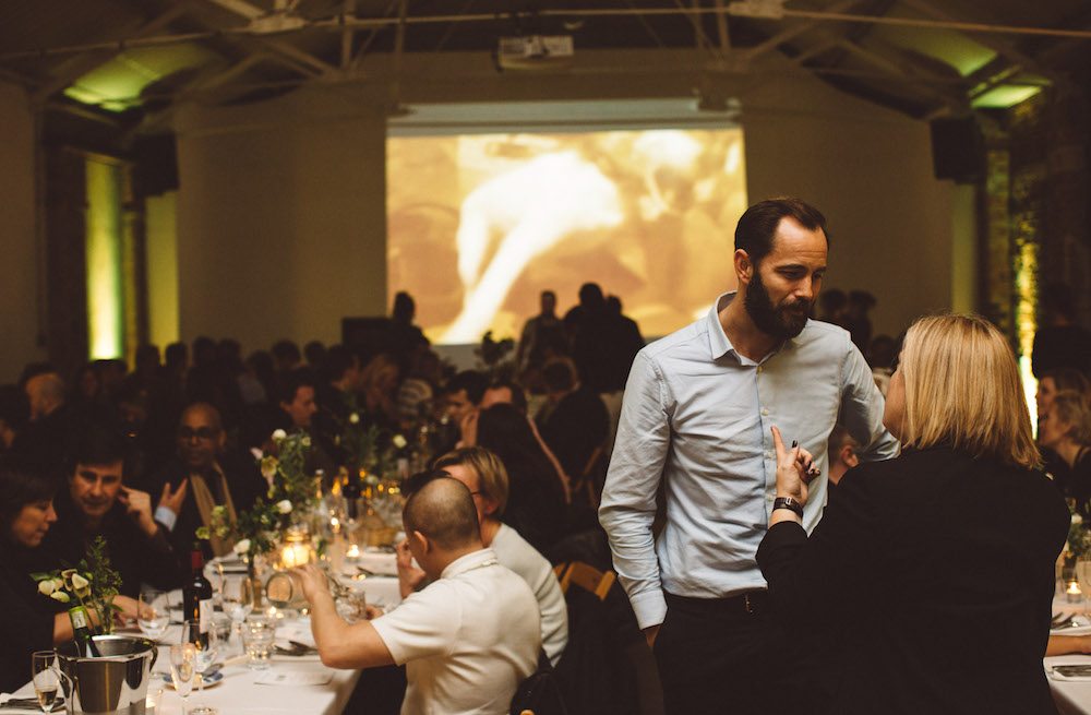 Vibrant event setting in Shoreditch Studios with elegantly set tables for networking.