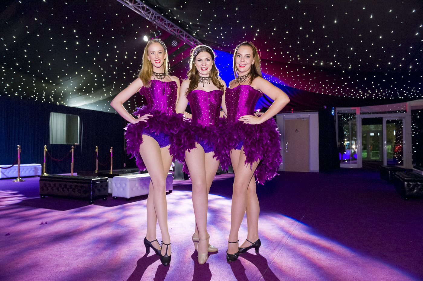 Vibrant event space with performers in glamorous costumes for corporate galas and celebrations.
