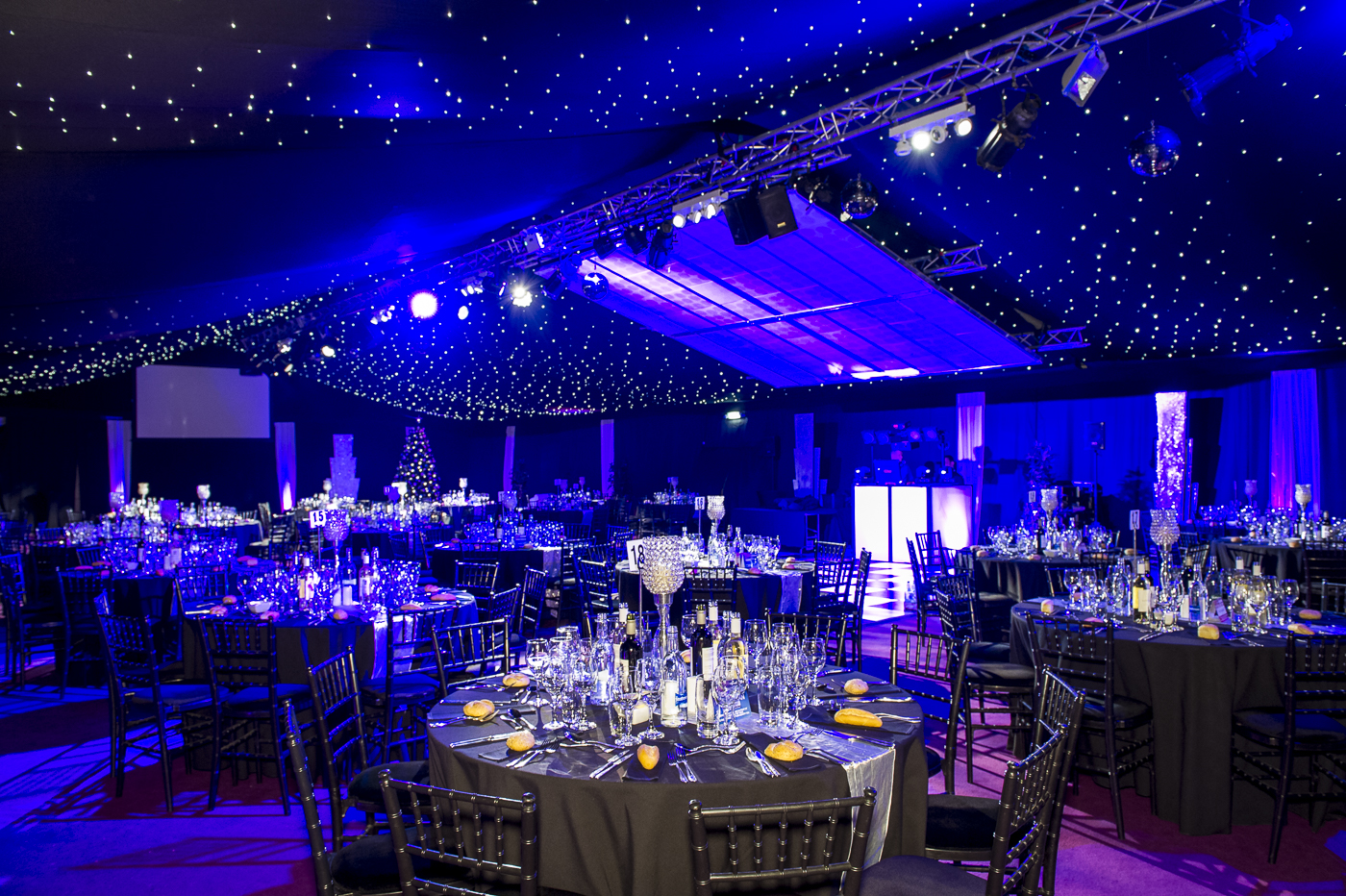 Elegant event space with starry ceiling, perfect for formal gatherings and celebrations.