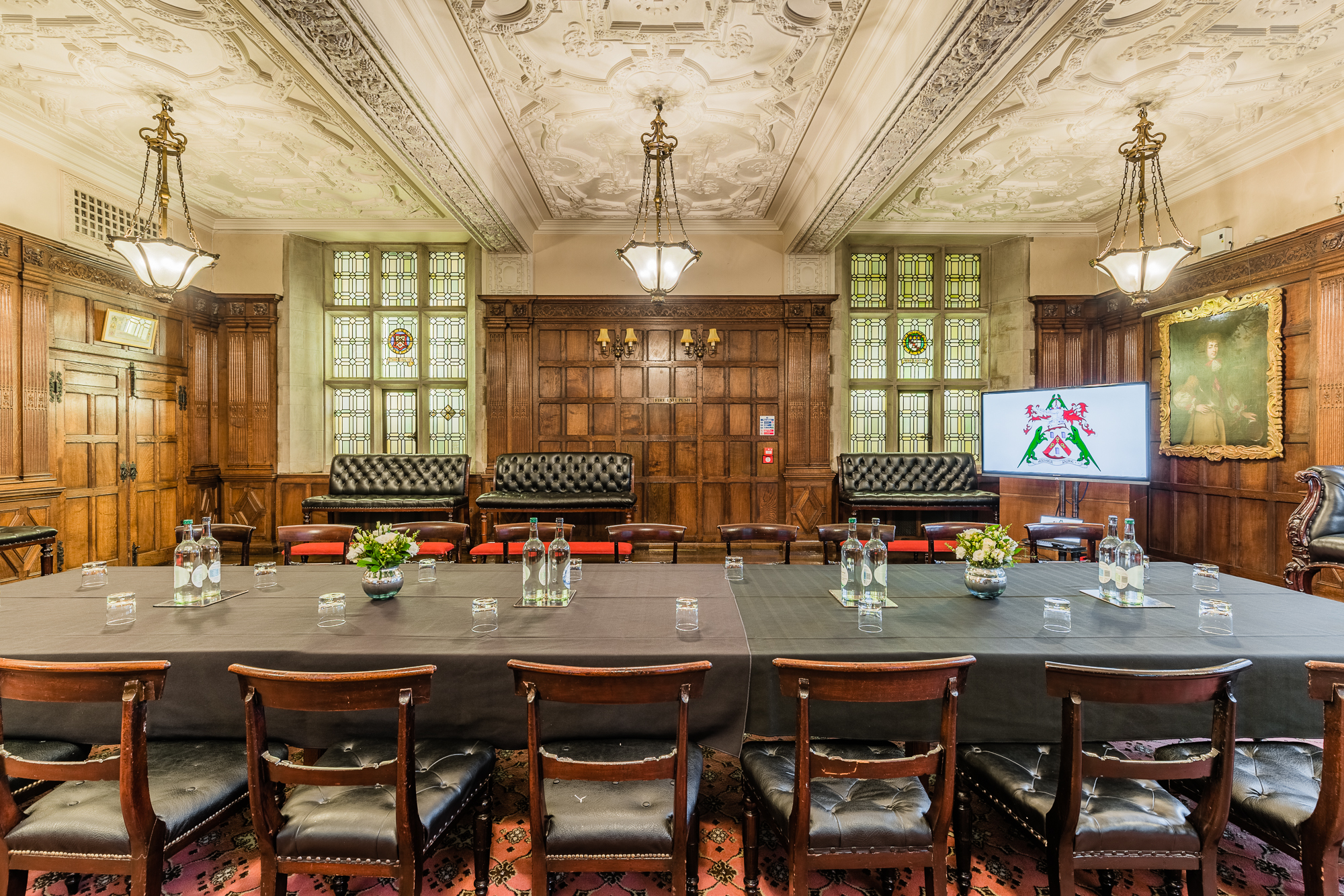 Elegant meeting room with wood paneling, ideal for conferences and presentations.