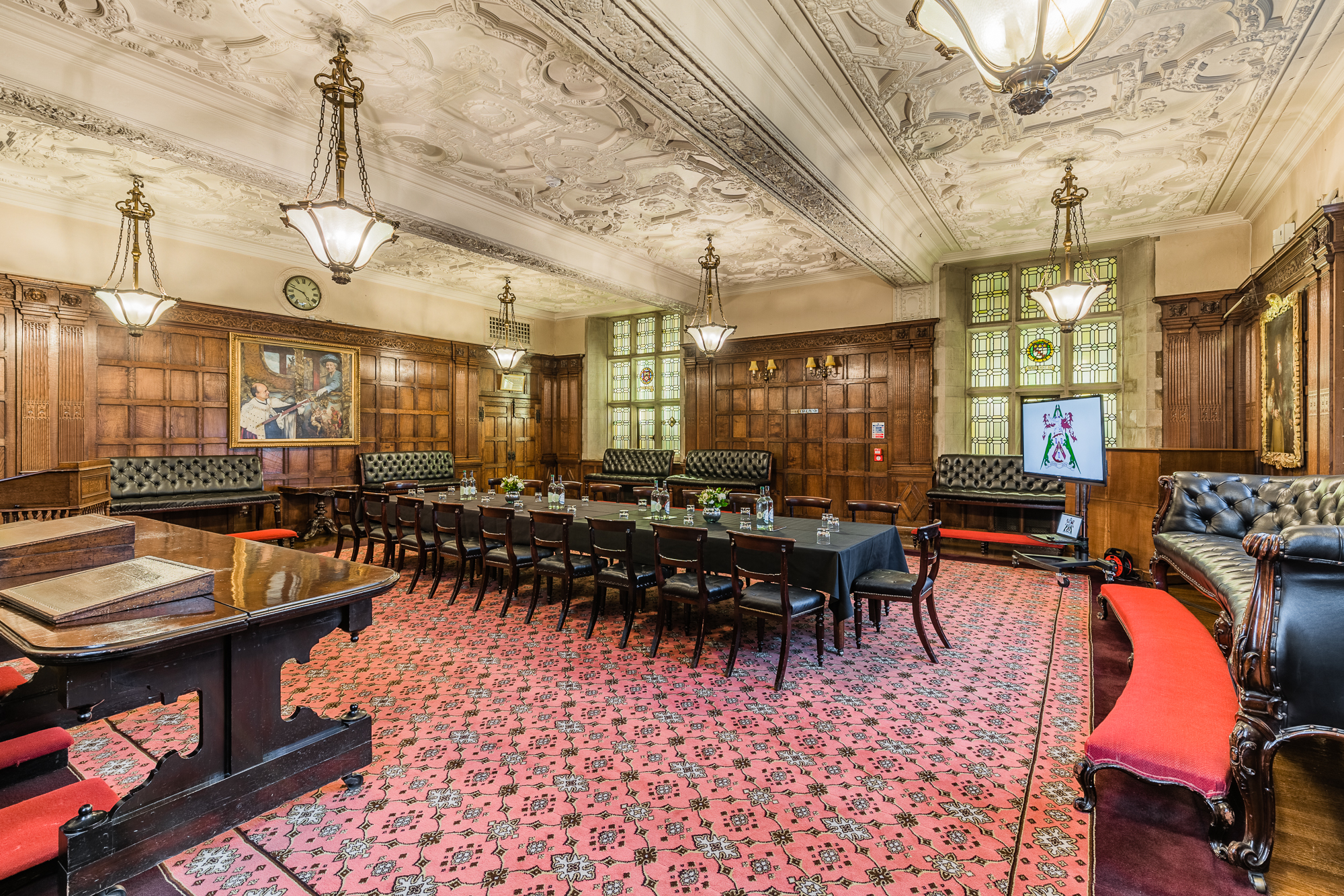 Elegant meeting room with wood paneling, ideal for high-level meetings and events.