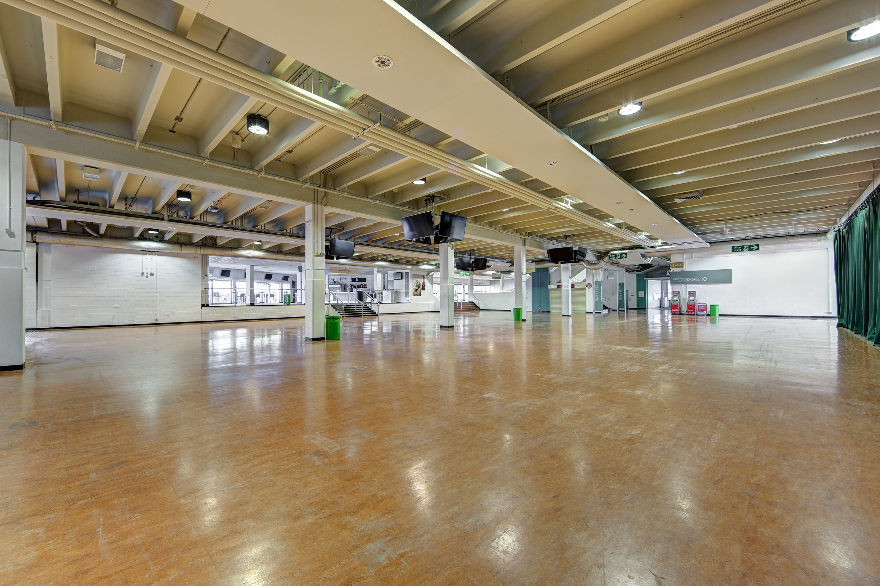 Surrey Hall at Sandown Park: spacious event venue with polished wooden floor, ideal for exhibitions.
