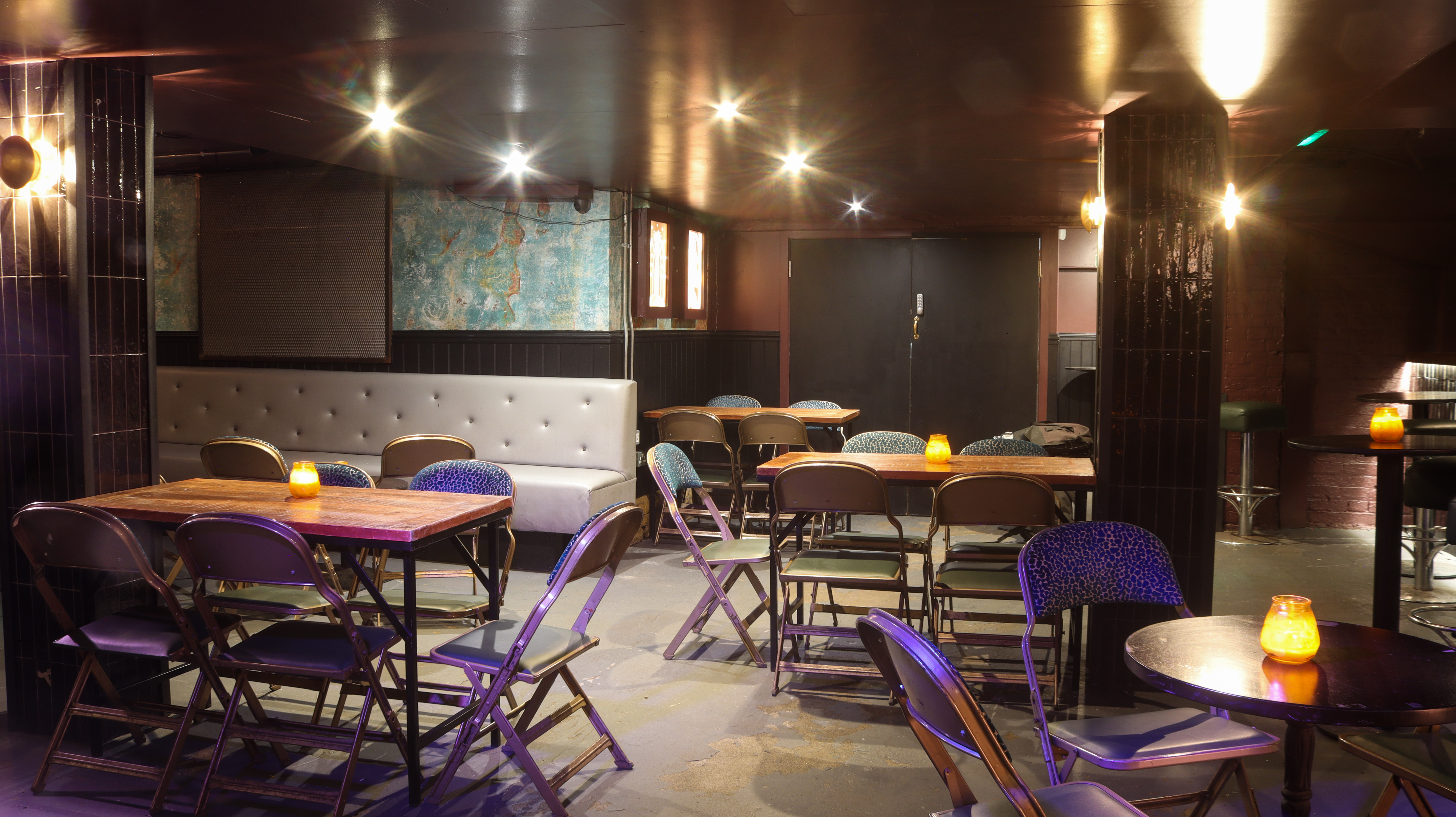 Intimate event space Behind the Bookcase with flexible seating for workshops and performances.