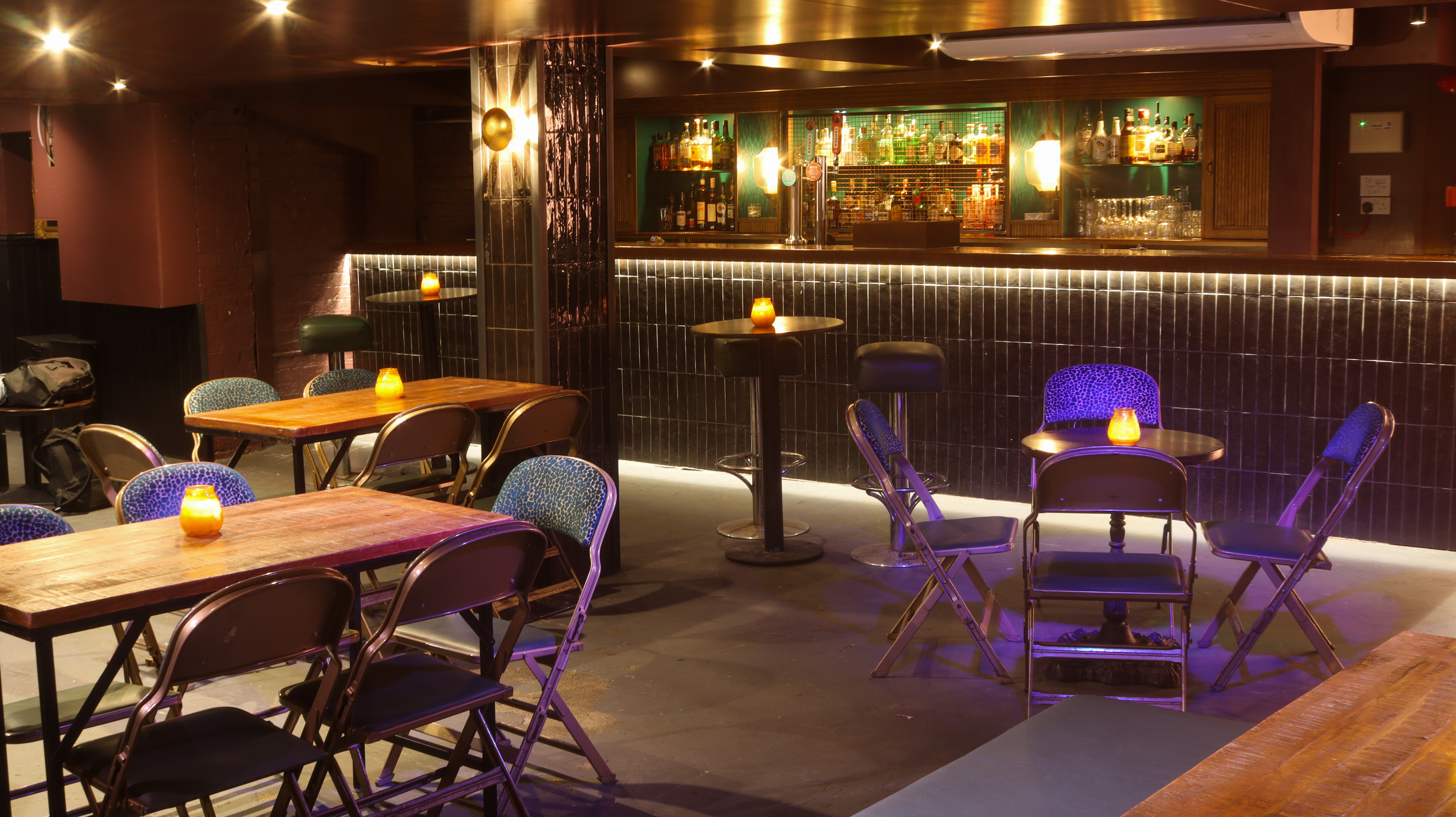 Stylish event space with wooden tables, ideal for networking and social gatherings.