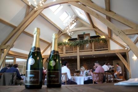Rustic Oak Barn event space with exposed beams, perfect for gatherings and corporate events.
