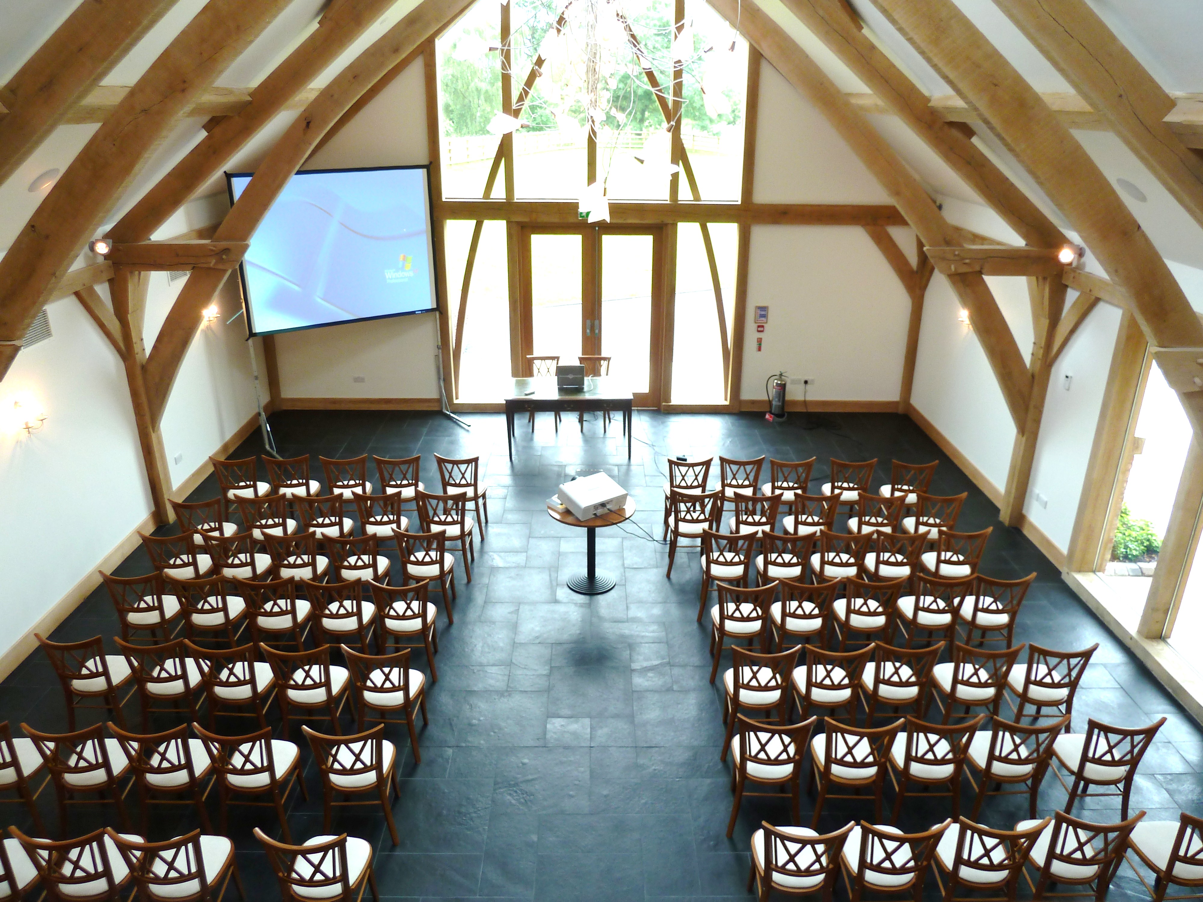 Oak Barn event space with wooden beams, ideal for meetings and workshops.