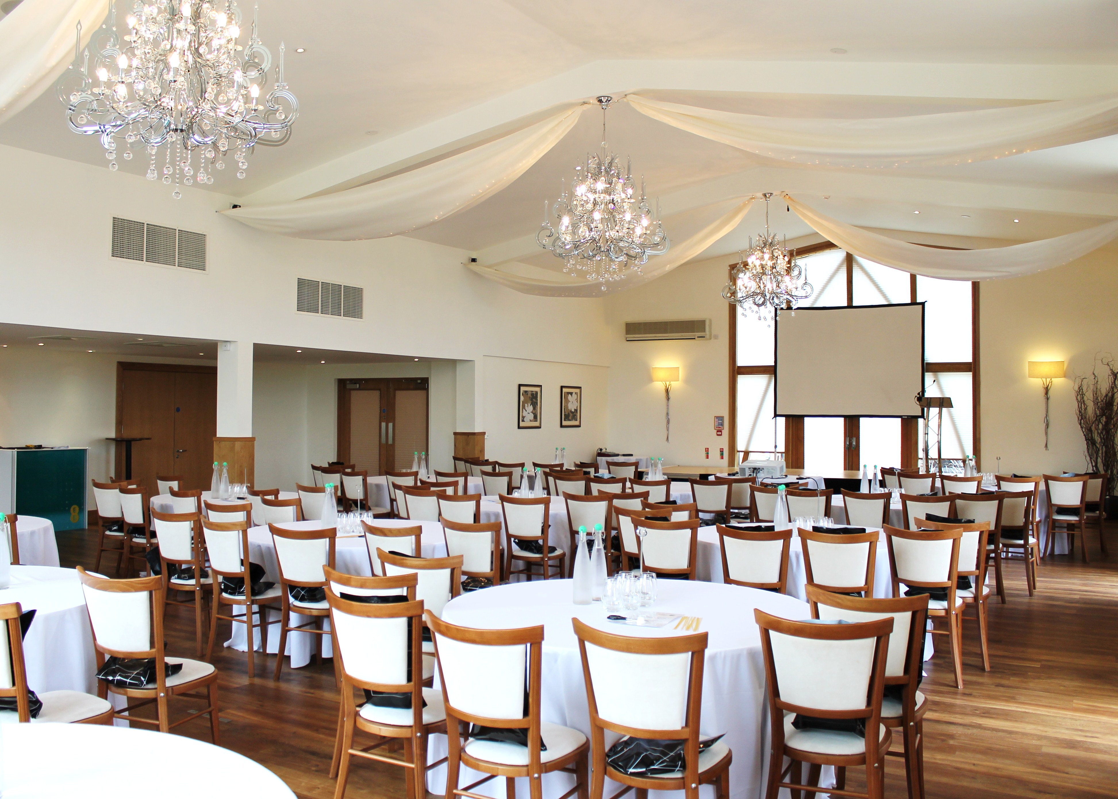 Elegant Grain Store event space with chandeliers, ideal for conferences and banquets.