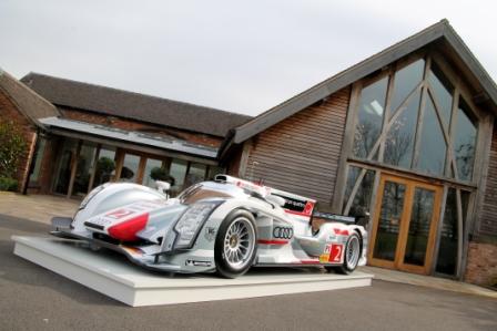 Sleek race car outside Mythe Barn Grain Store for high-energy events and product launches.