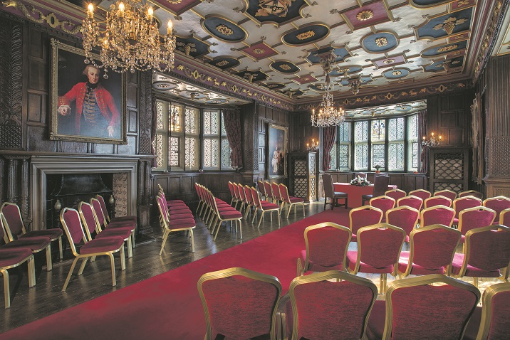 Elegant meeting space with ornate ceiling, ideal for corporate events and workshops.