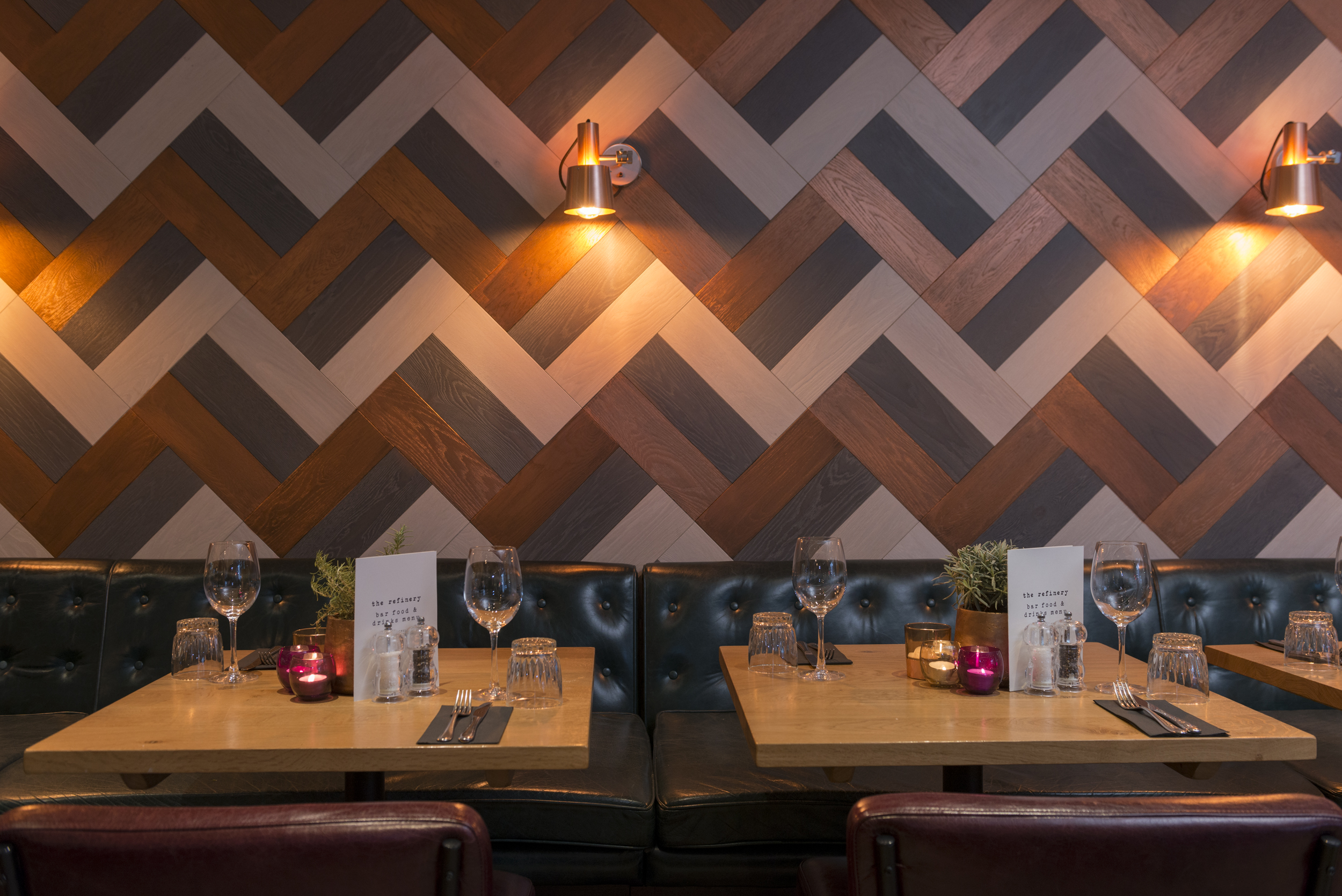 Stylish dining area with chevron wall, perfect for upscale events and private dinners.