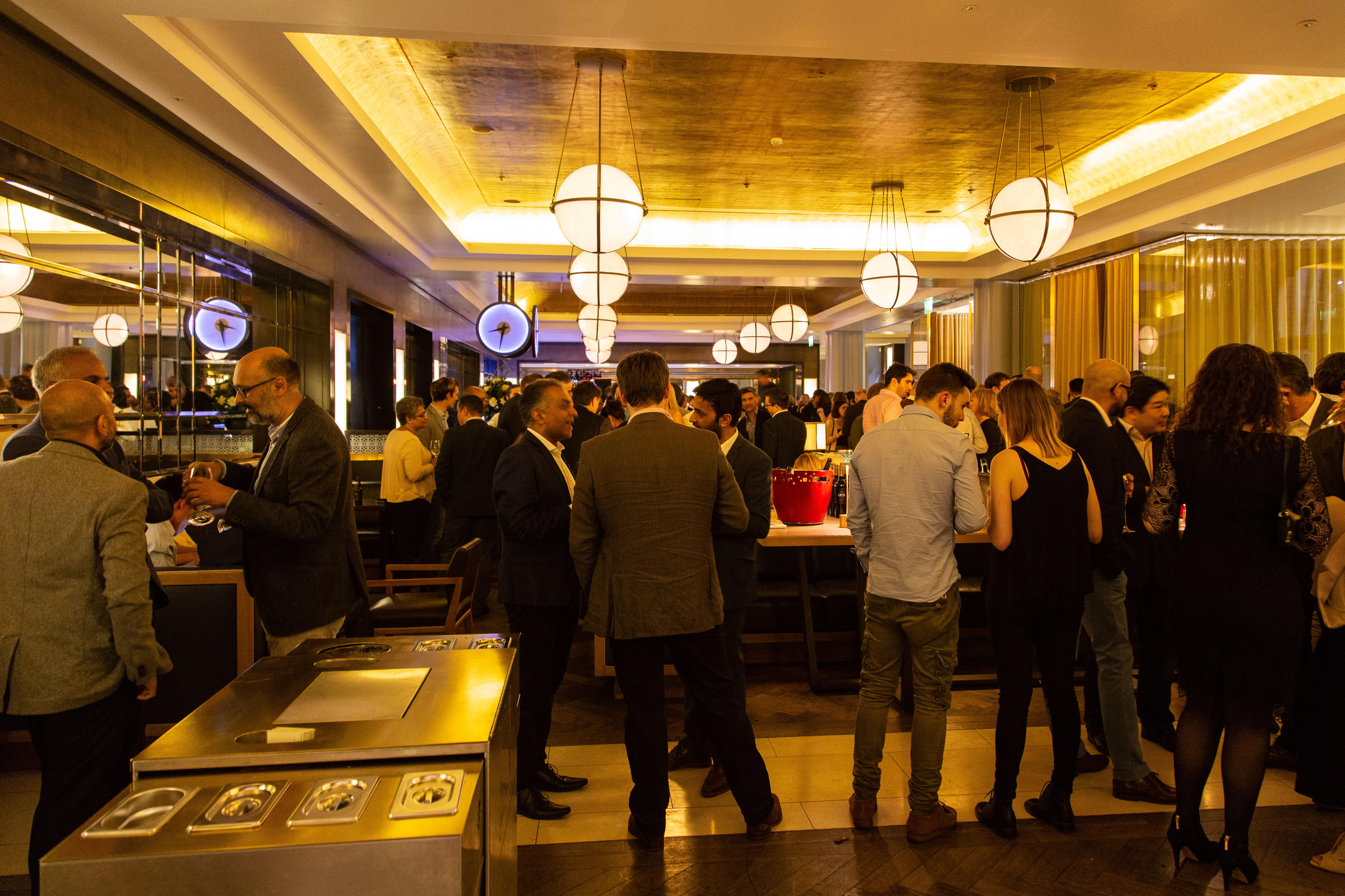 Vibrant networking event at St Pancras Brasserie with modern decor and ambient lighting.