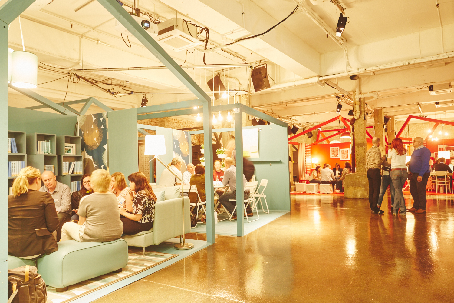 Vibrant event space with cozy booths for networking and collaboration at The Warehouse.