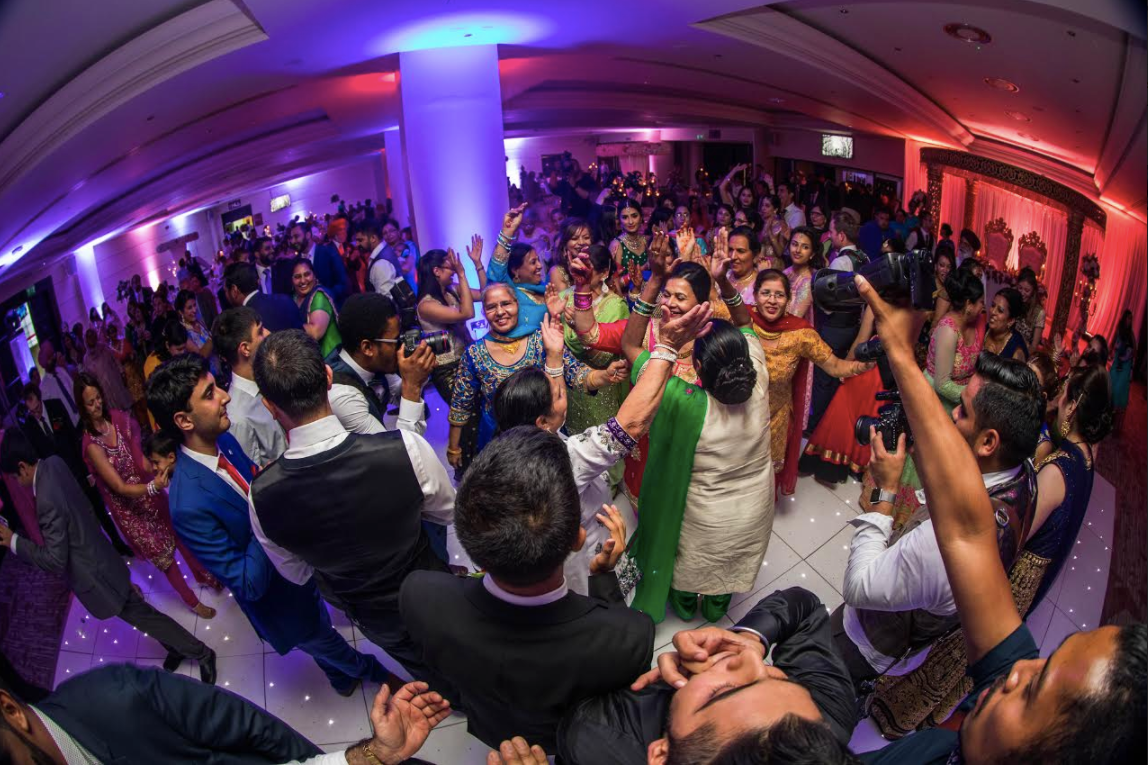 Vibrant Rose Suite event at Allianz Stadium, Twickenham with colorful lighting and engaged crowd.