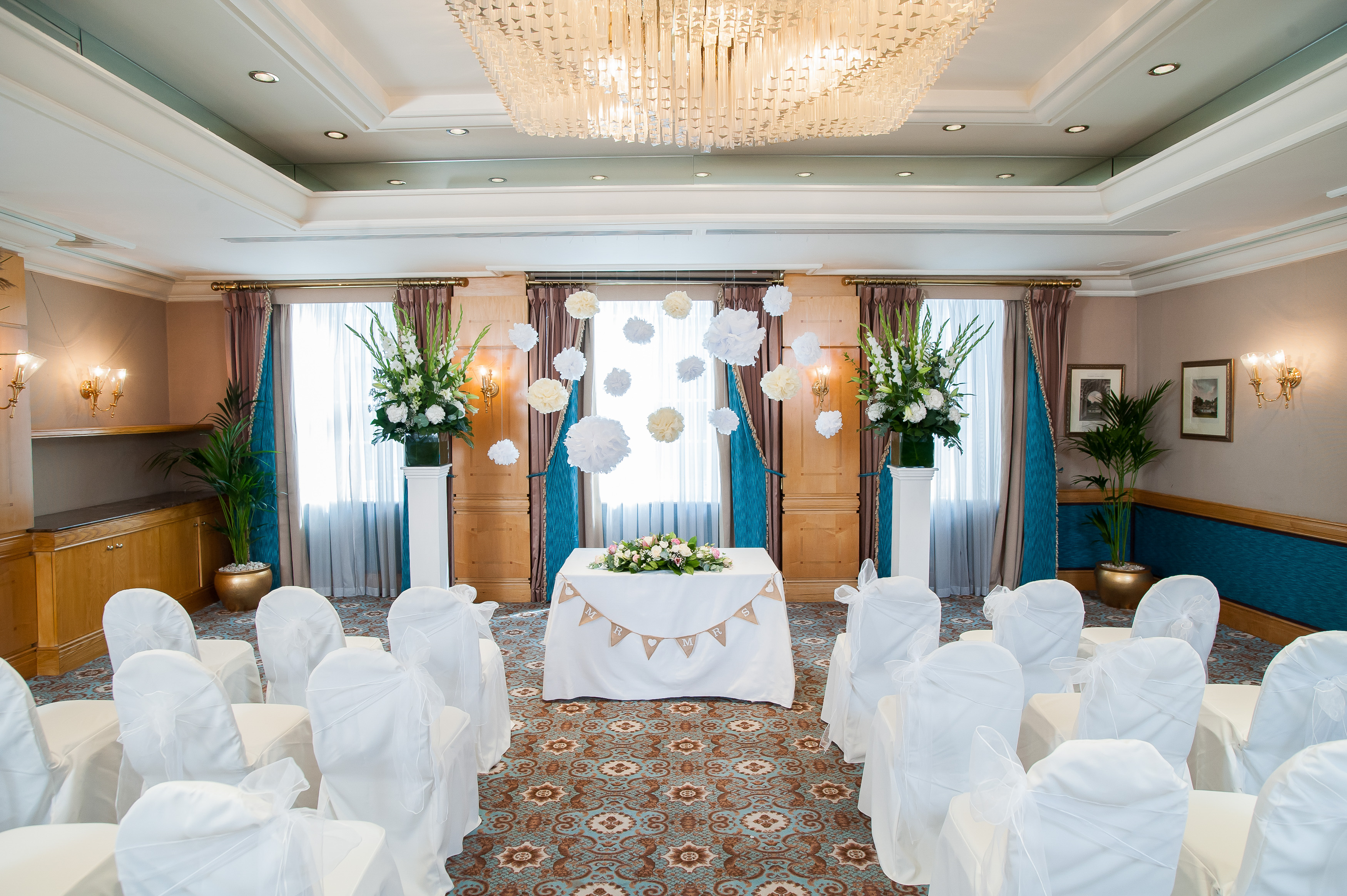 Elegant wedding venue with white drapery and floral decor at The Rubens at the Palace.