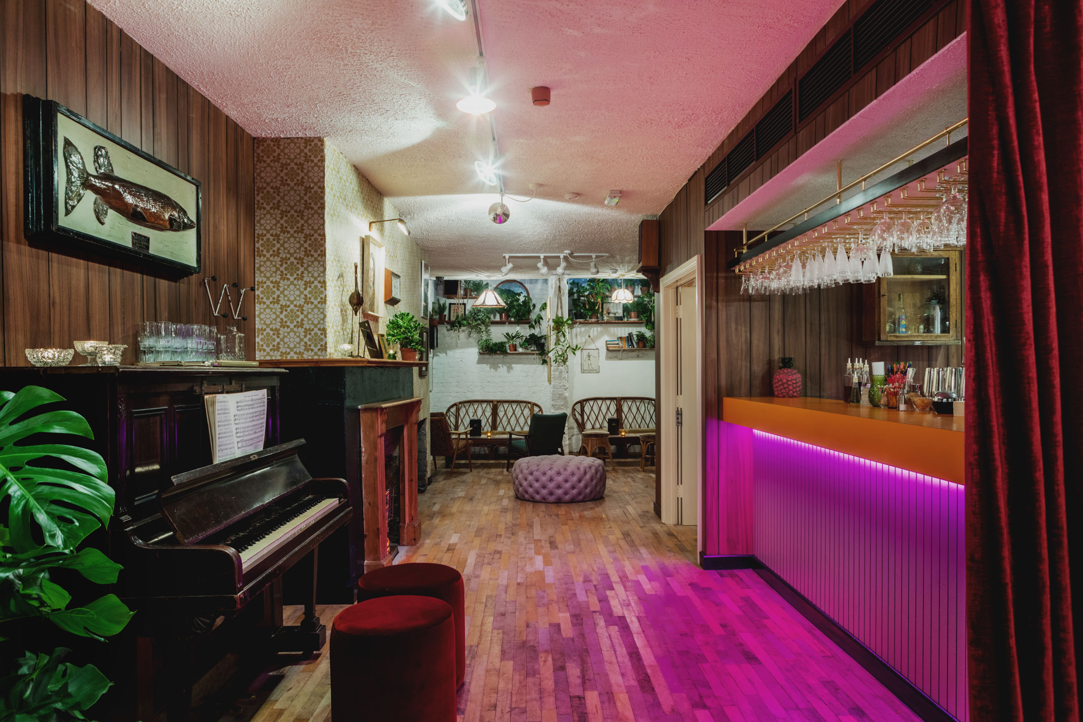 Stylish basement bar with vibrant lighting, ideal for networking events and live music.