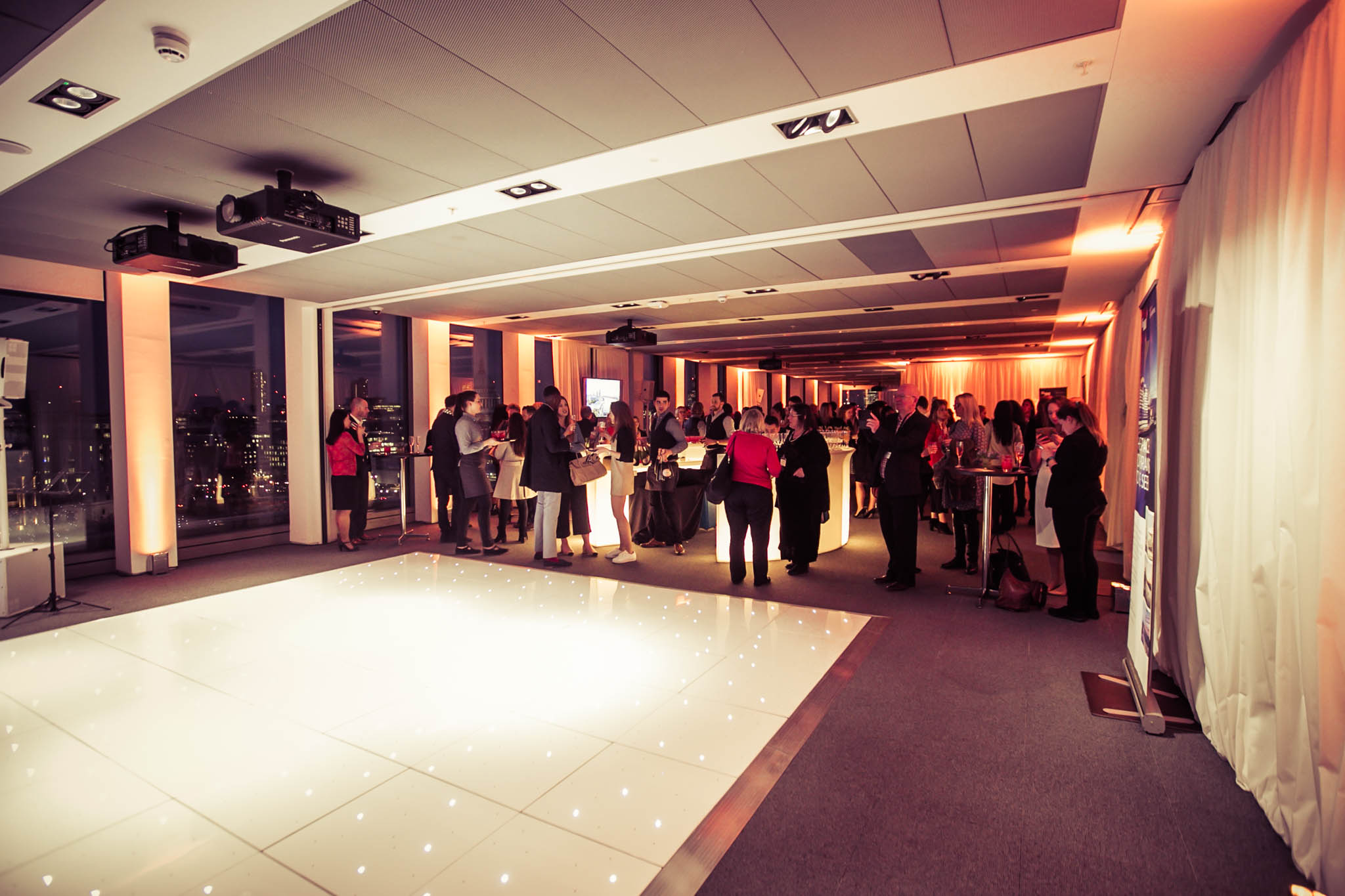 Sophisticated event space with panoramic city view for corporate gatherings and celebrations.