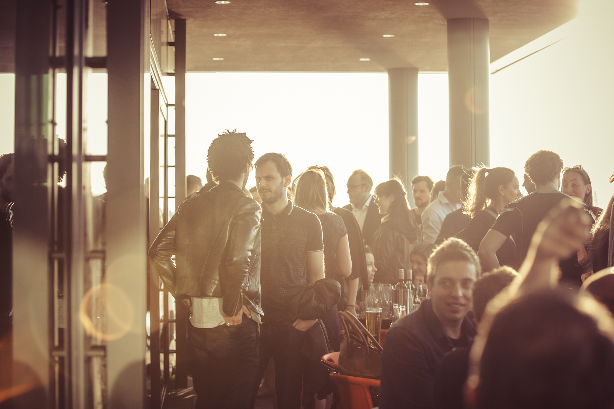 Vibrant sunset networking event at Sea Containers, featuring warm lighting and engaged attendees.