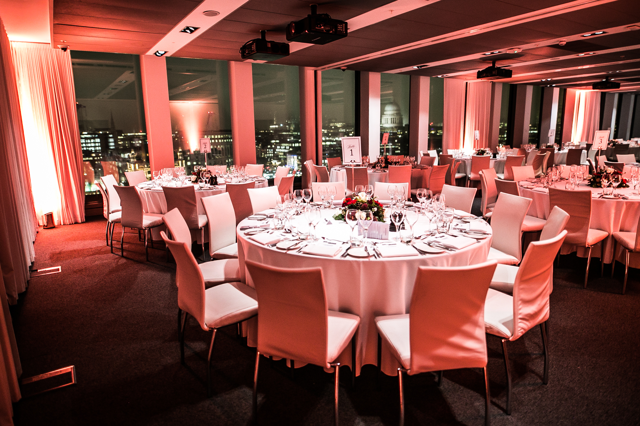 Elegant dinner setup at Sea Containers Events with city view, perfect for corporate gatherings.