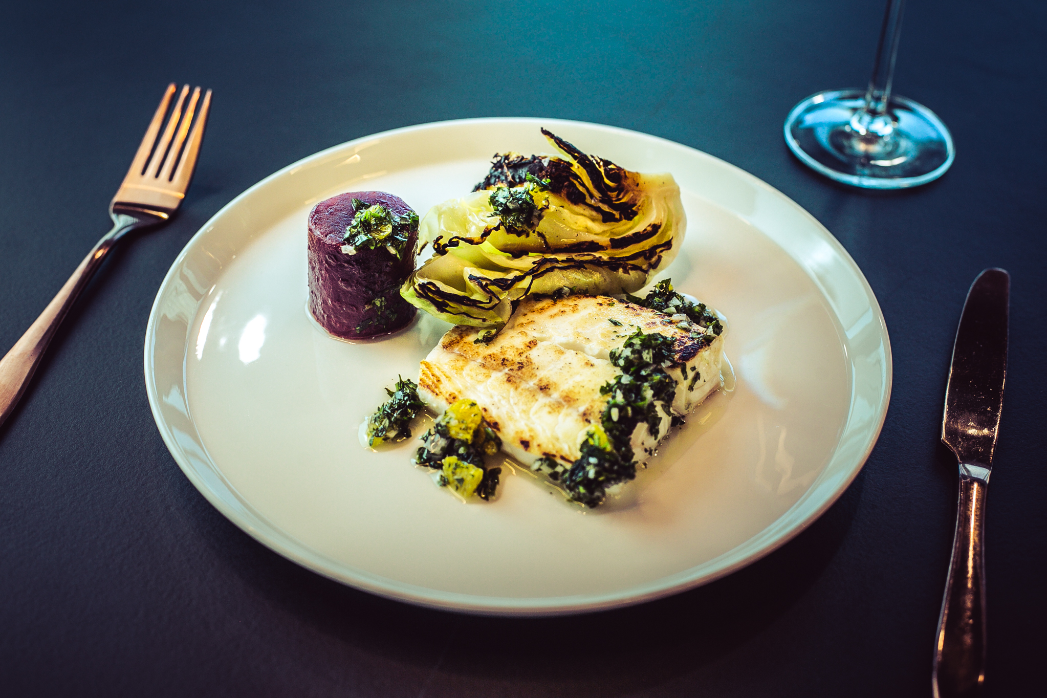 Elegant fish dish with grilled greens at Sea Containers Events dining experience.
