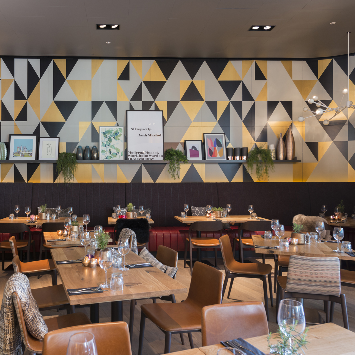 Stylish restaurant venue with geometric walls for corporate events and gatherings.