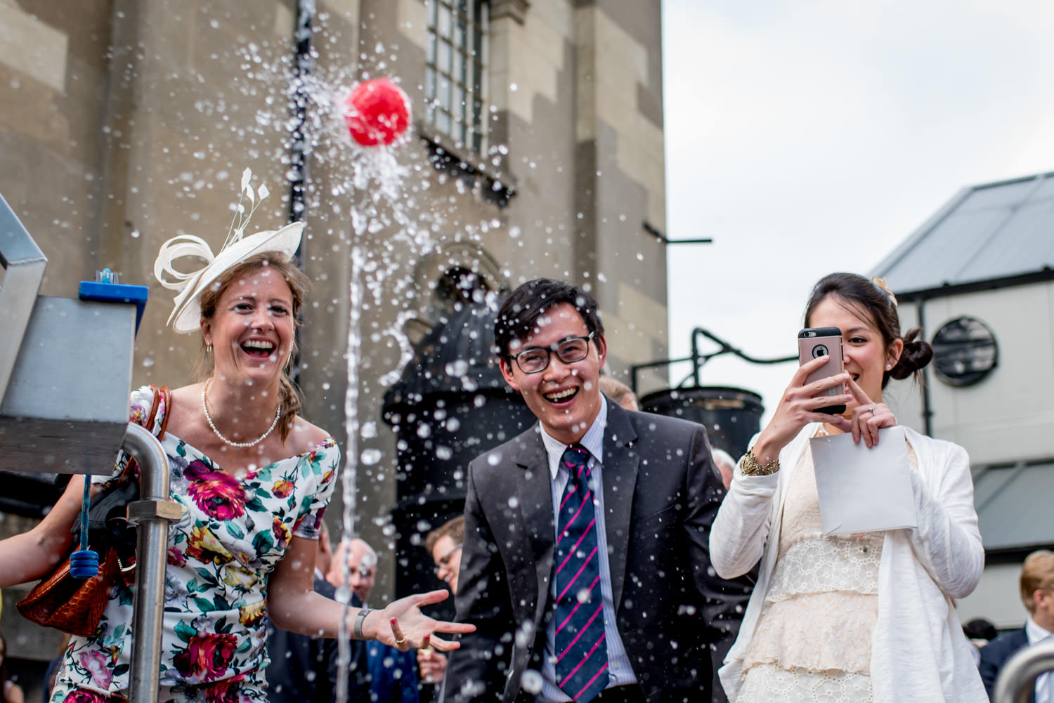 Outdoor event at London Museum of Water & Steam with guests splashing water joyfully.