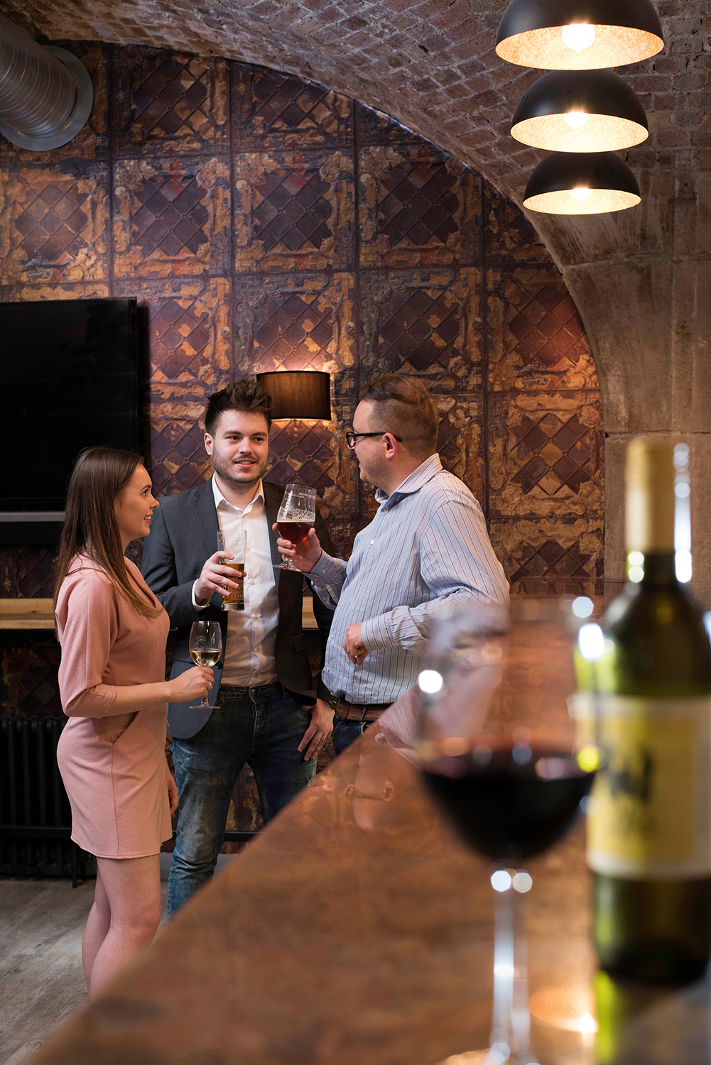 Networking event at Dock Street Bar with elegant decor and warm lighting.