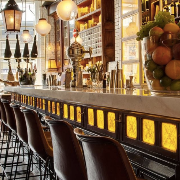 Stylish bar area with marble countertop, ideal for networking events and cocktail receptions.